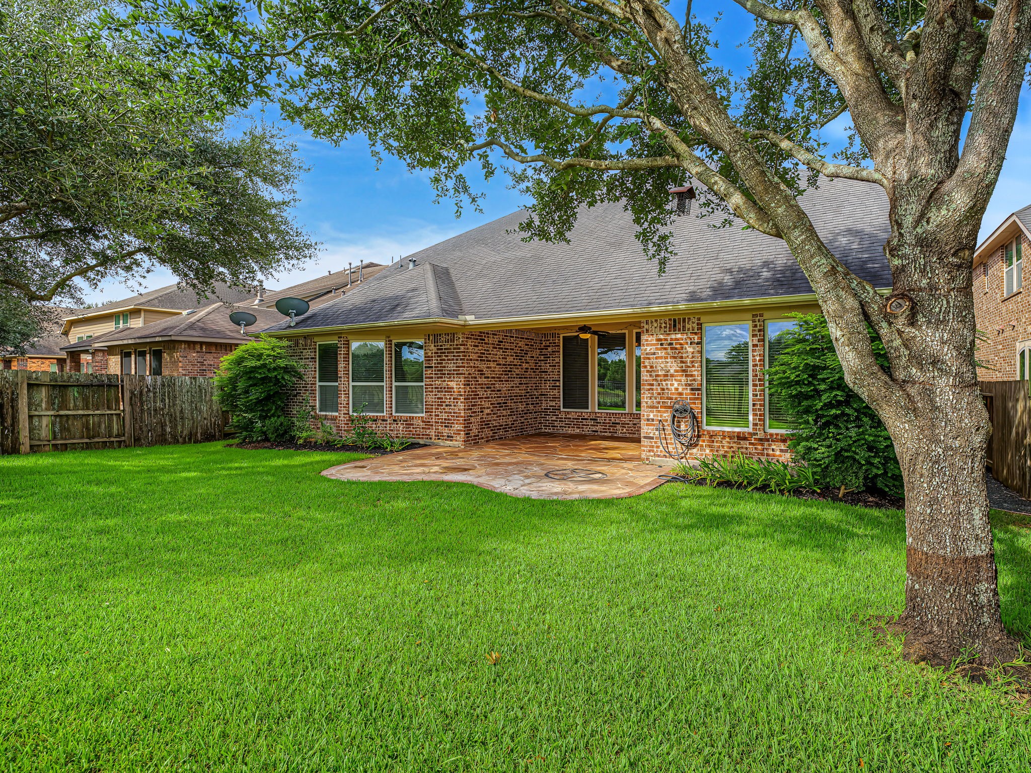 Mature trees provide shade and are trimmed up, so you can look to the pond.