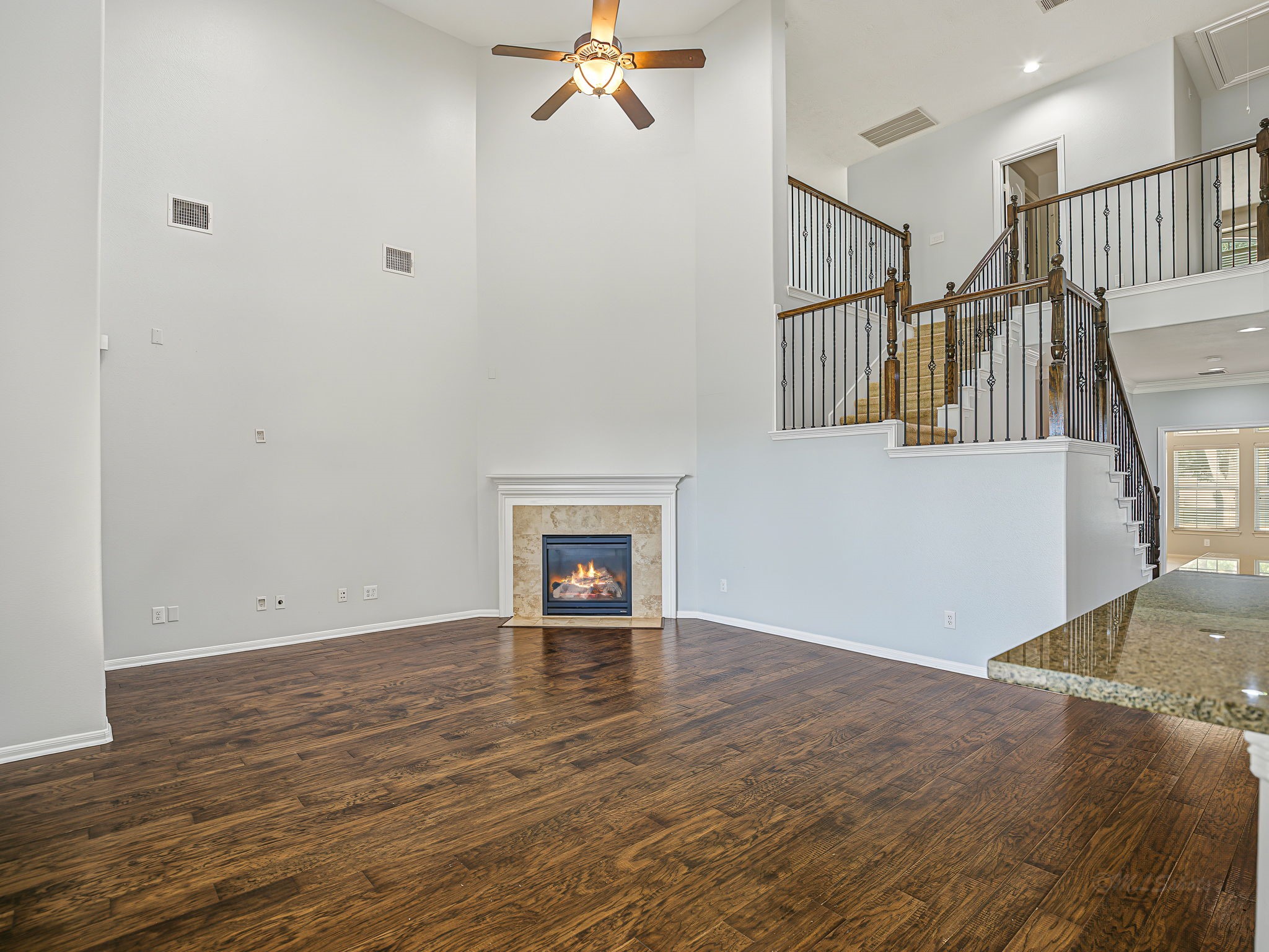 Gorgeous, 2 story family room! See how you could set it up with that fireplace as the center piece! How about that dramatic staircase!