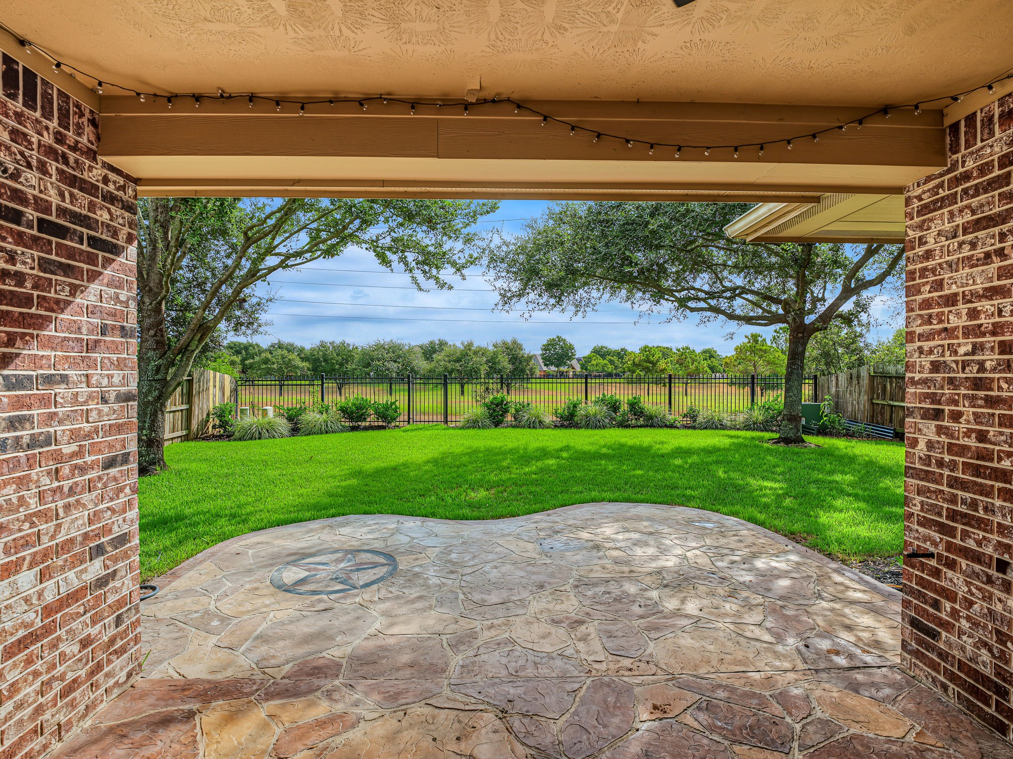 Extended, stamped cement, covered patio! No back neighbors! Green and a large pond (small lake?) beyond!