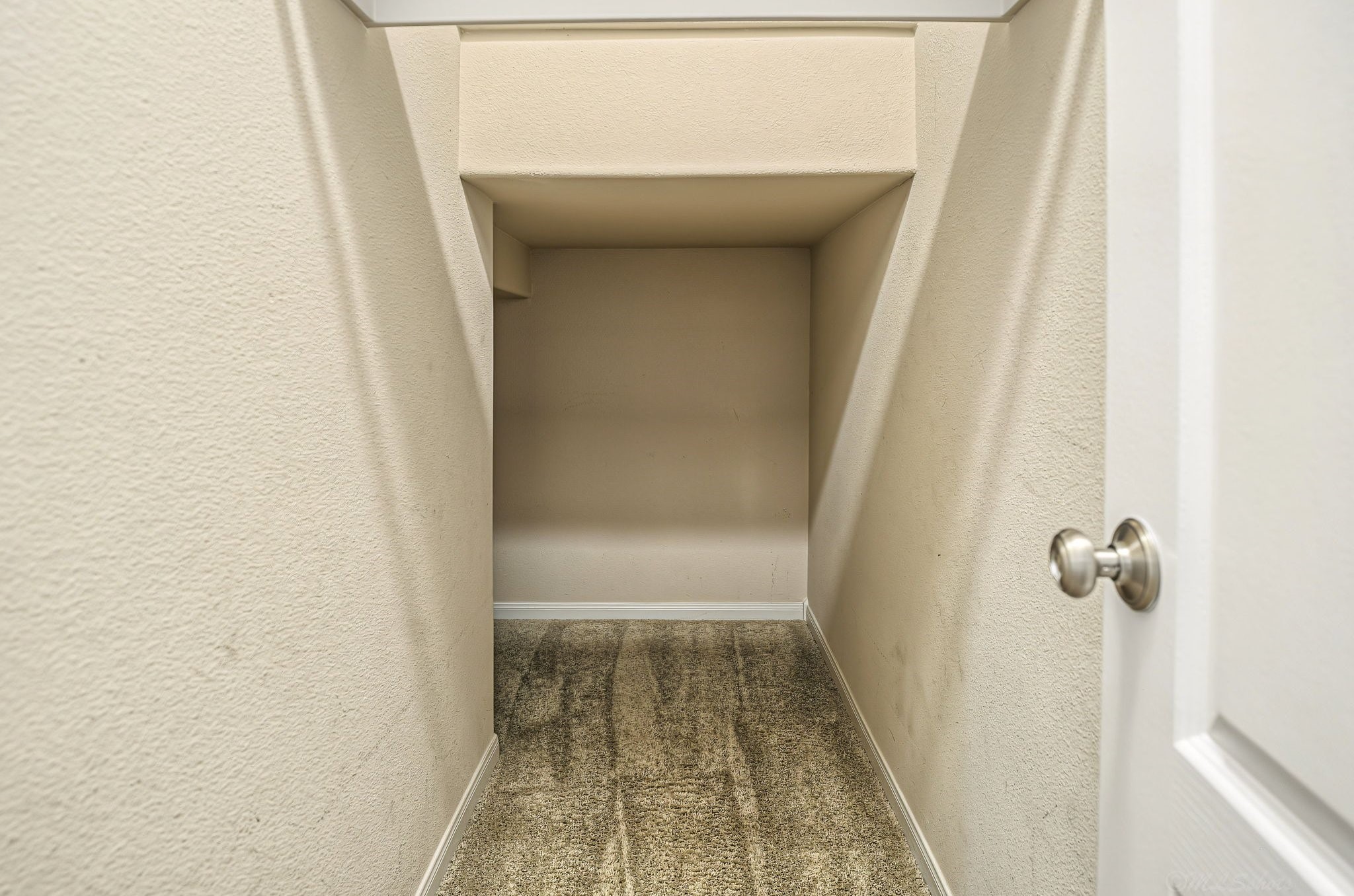 Storage closet that wraps around under the staircase!