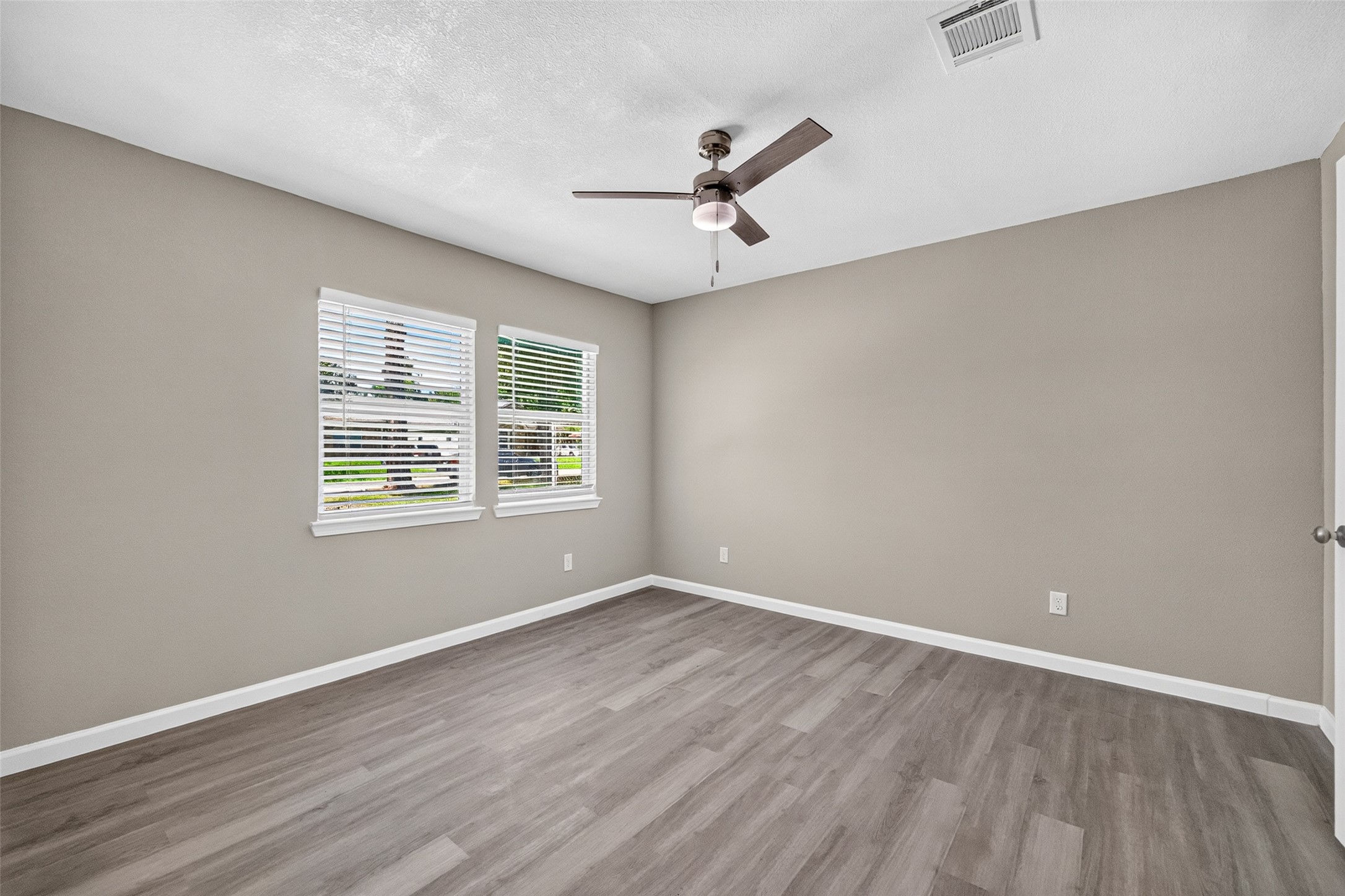 Primary bedroom with ceiling fan