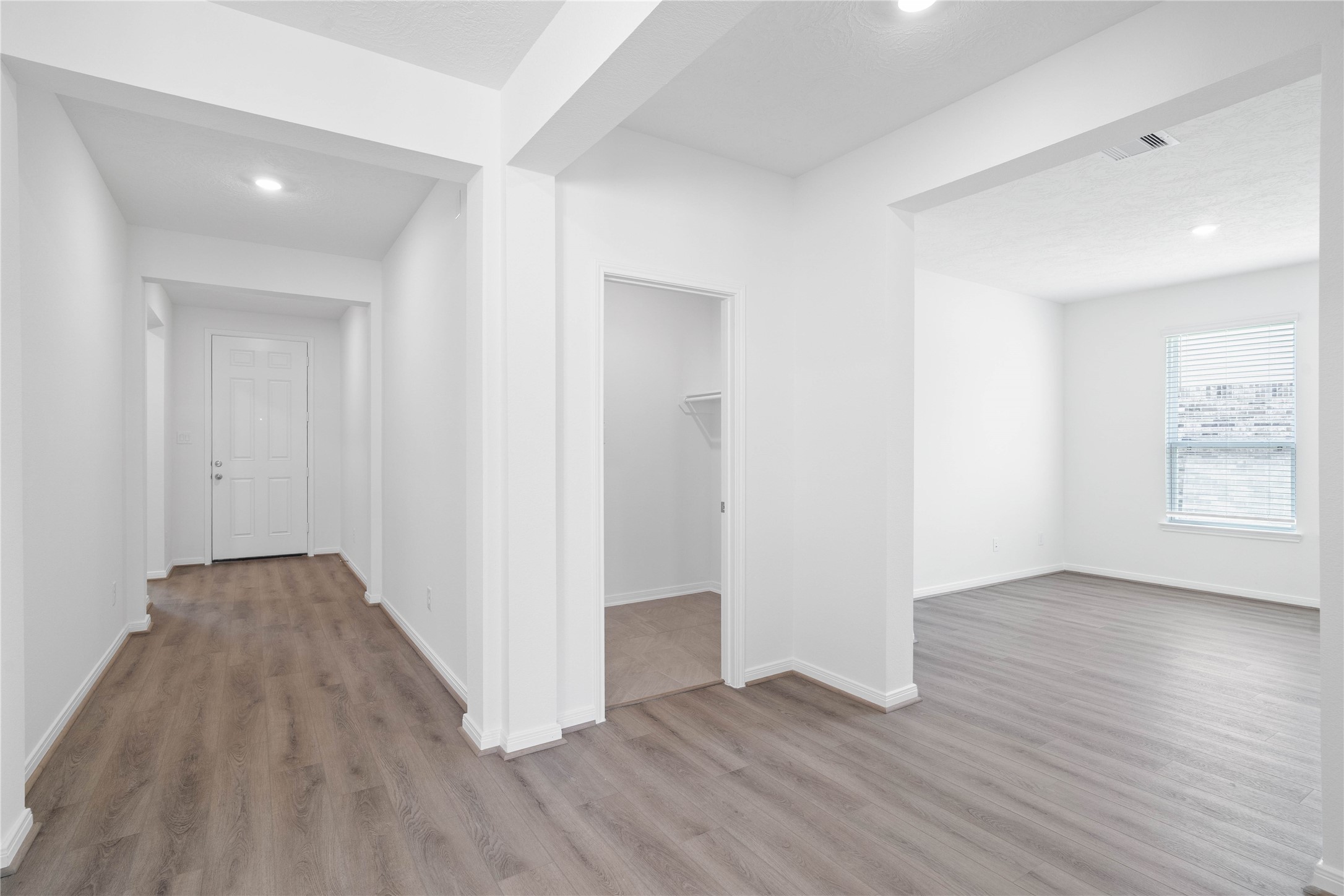 Across the home from the secondary bedrooms and bathroom is a hallway that leads to the Den and laundry room.
