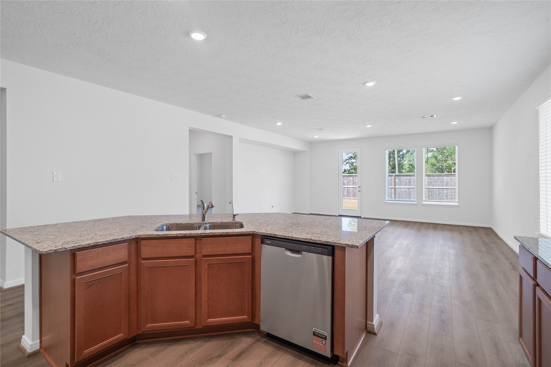 The heart of this home is bathed in abundant natural light and creates a bright, airy atmosphere that enhances the entire open-concept living area.