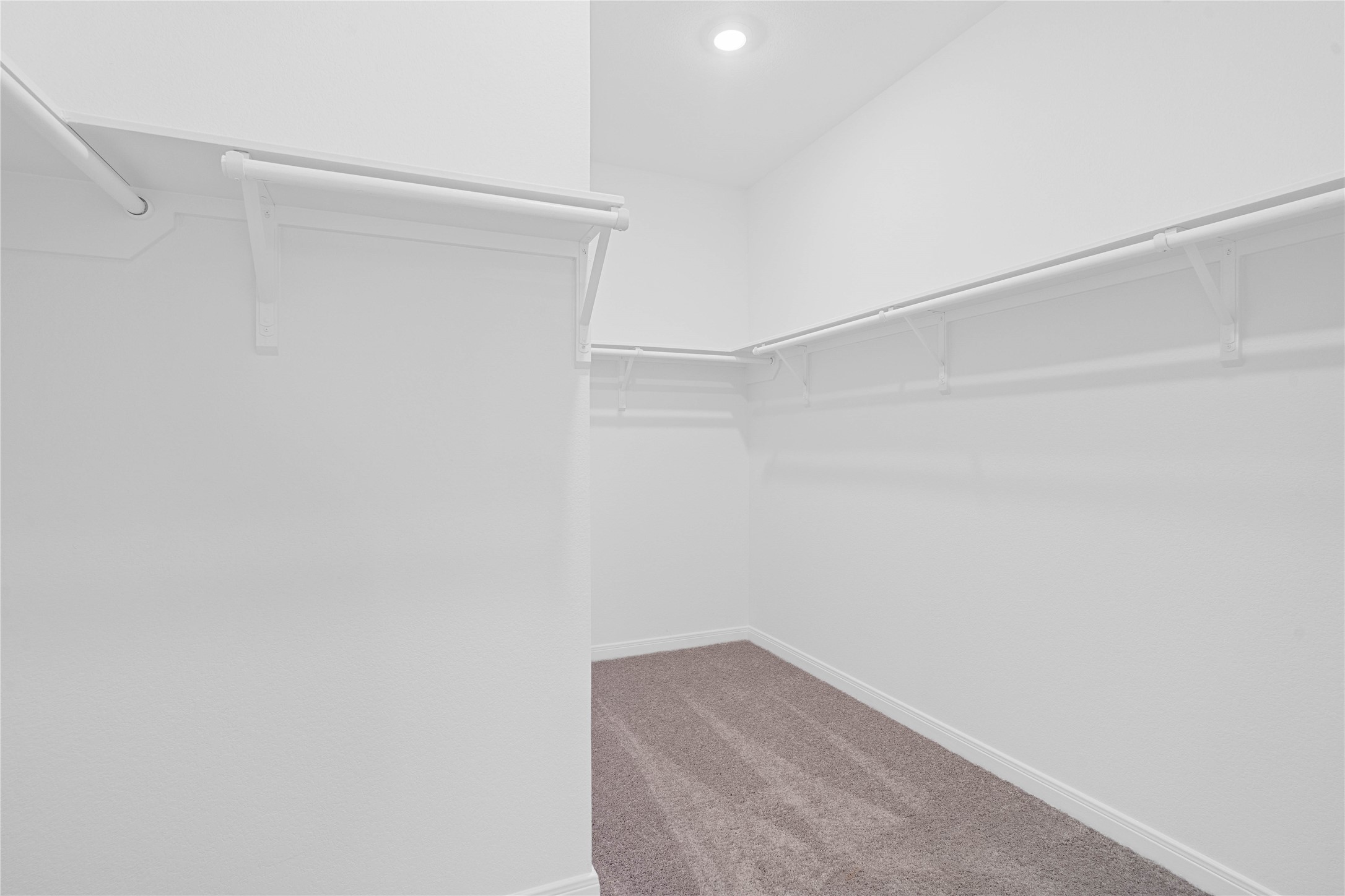 Experience the convenience of a spacious walk-in closet designed to simplify your morning routine. There is plenty of room to keep your wardrobe organized and easily accessible.