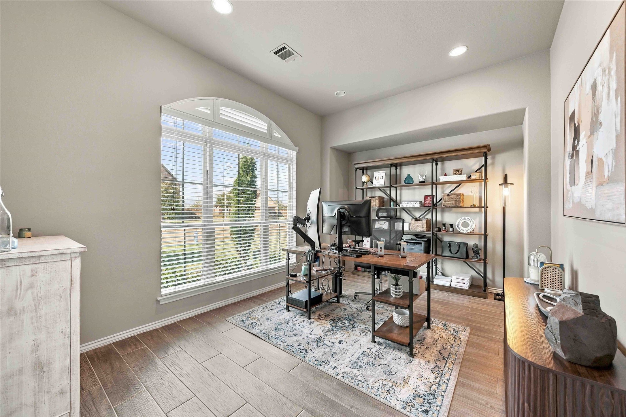 Bright and spacious home office featuring a large arched window that provides alot of natural light Bright and spacious home office featuring a large arched window that provides alot of natural light