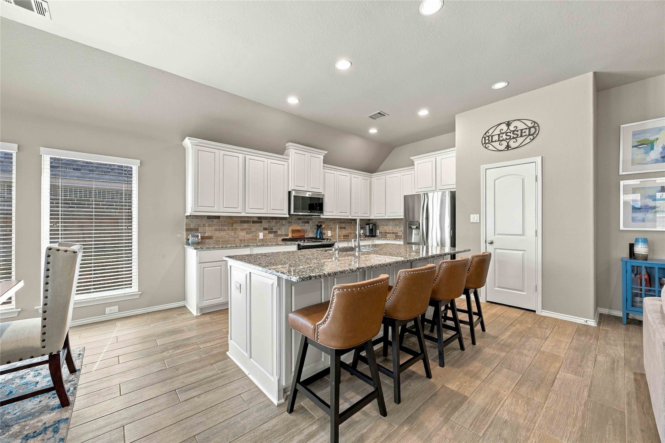 The spacious kitchen island serves as a beautiful focal point, offering additional prep space and the perfect spot for casual dining, entertaining, and gathering with family and friends.
