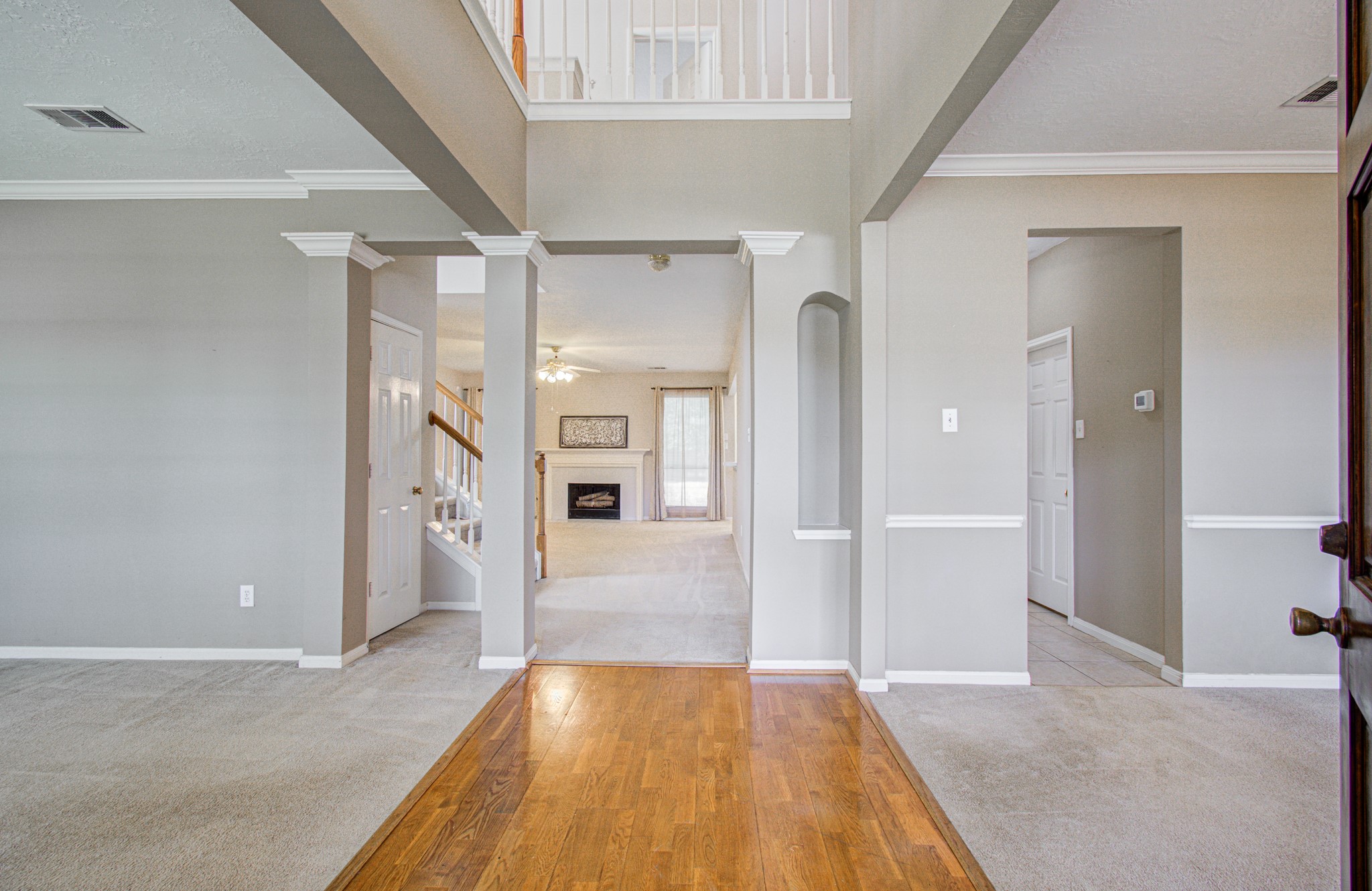 Soaring two-story entry welcomes you inside, creating an open, airy first impression with access to the home's formal living and dining spaces.