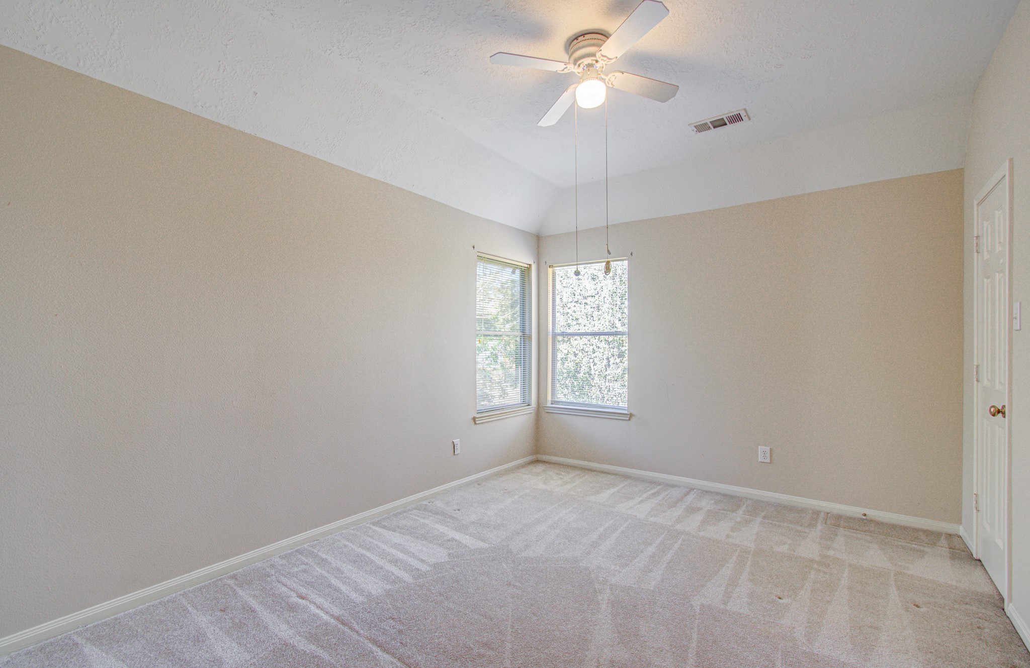 Generously sized secondary bedroom offers flexibility for a bedroom, home office or creative space, with access to the upstairs shared bathroom.