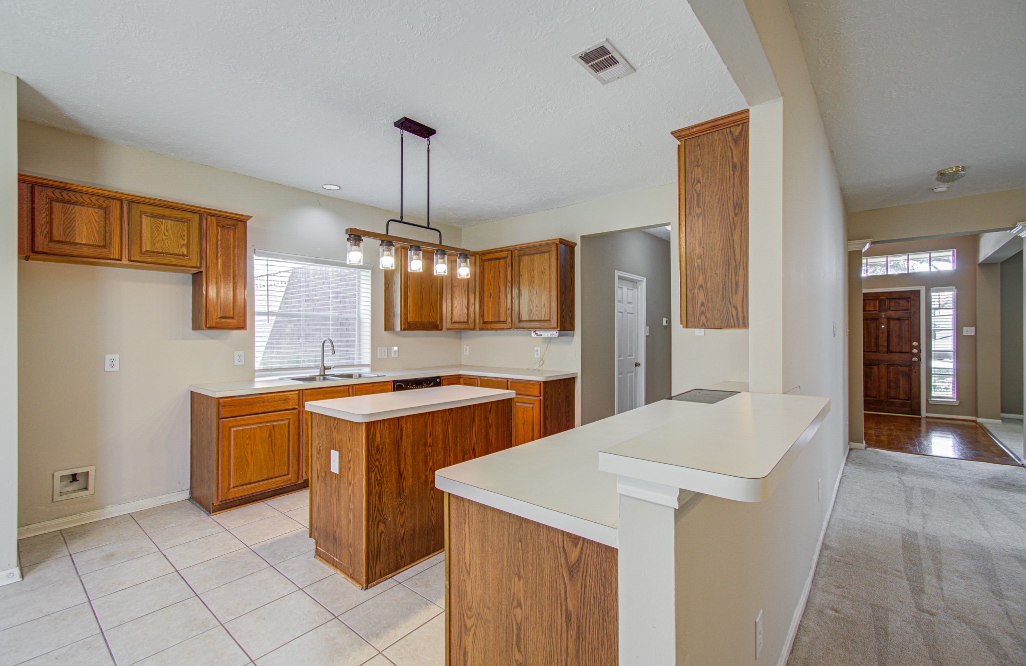 Connected for everyday living! Kitchen offers an island for additional prep space, plentiful cabinet storage and an easy flow to the adjoining gathering areas.