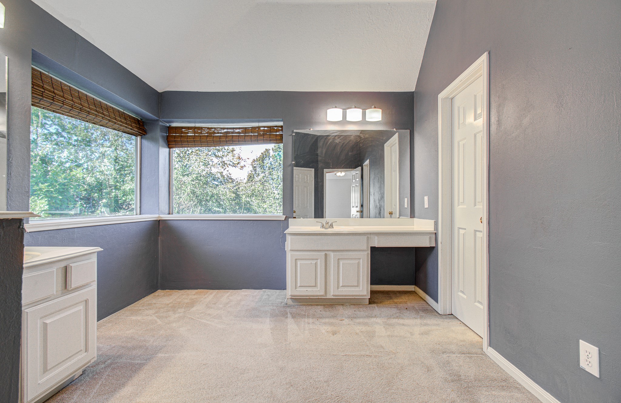 Natural light fills this generously sized primary bath, featuring two separate vanities and plenty of space for everyday routines.
