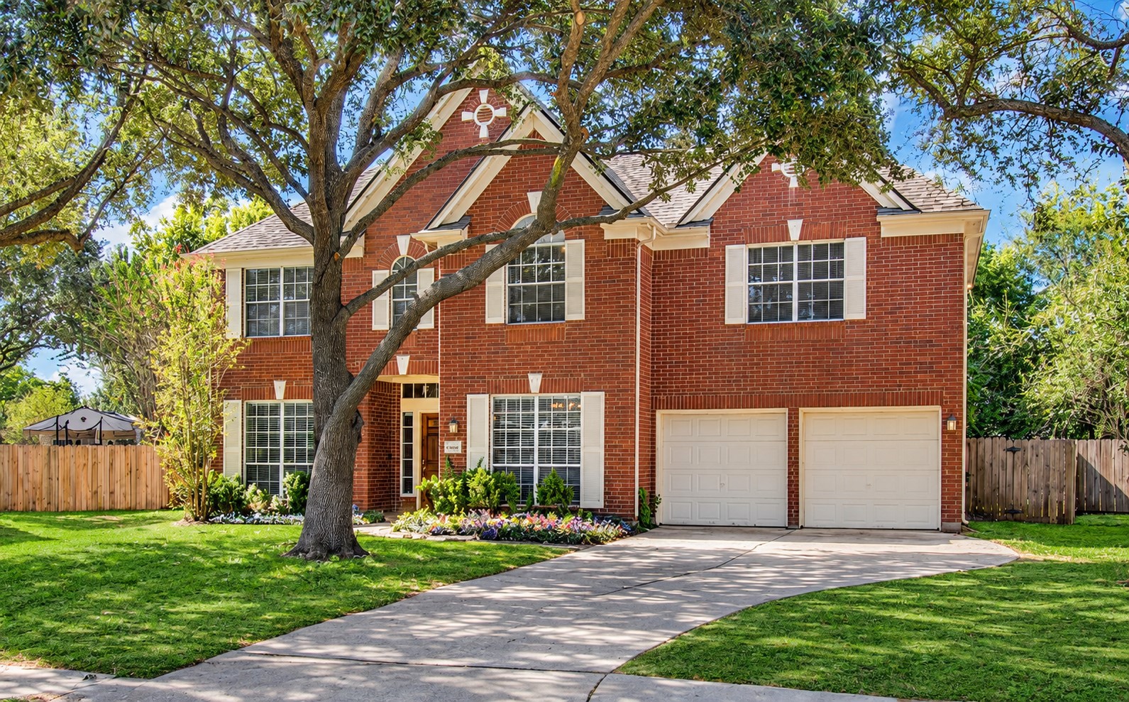 WELCOME HOME! Beautiful brick exterior, mature shade trees, established landscaping and a two-car garage create an inviting first impression.