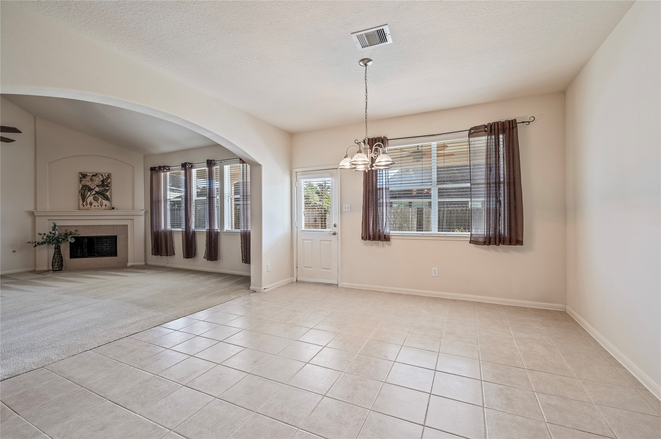 The breakfast area overlooks the covered back patio and large backyard.