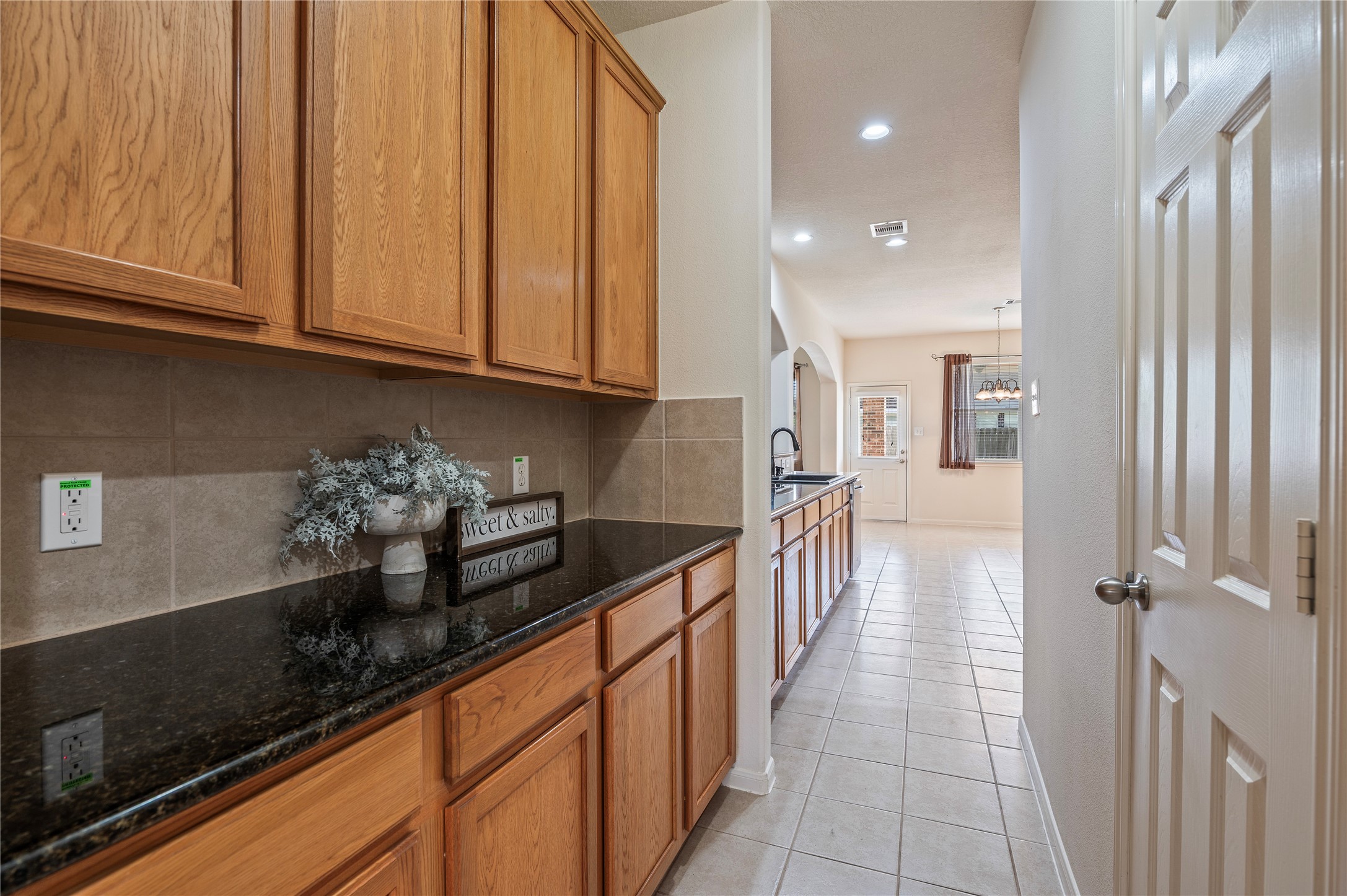 A butler's pantry with extra counter space connects the kitchen and dining room, perfect for serving and storage.