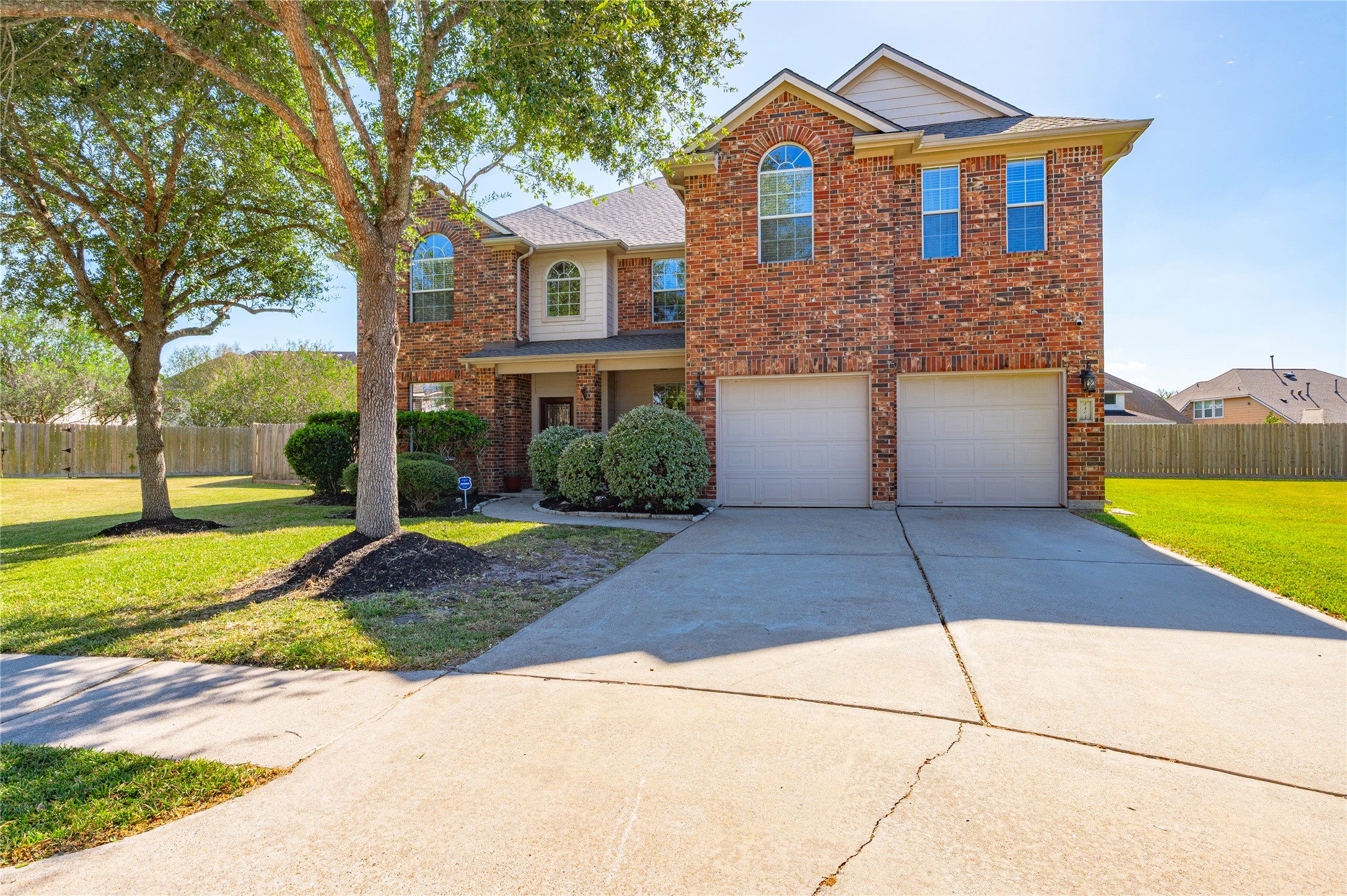 The extra-wide driveway leads to an attached 2-car garage with automatic door opener, with room for additional parking. The extra-wide driveway leads to an attached 2-car garage with automatic door opener, with room for additional parking.