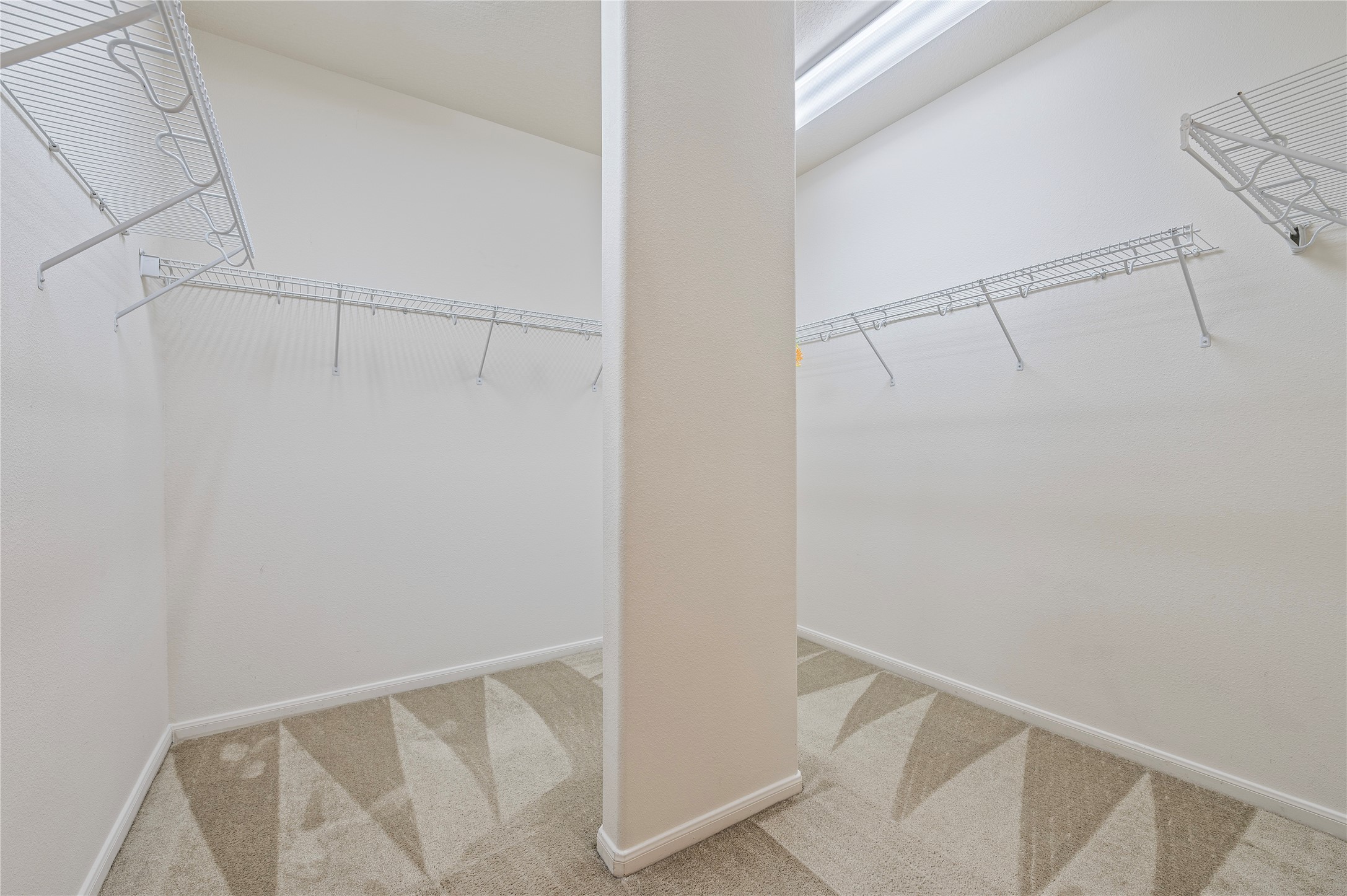 The oversized primary walk-in closet offers plenty of storage space.
