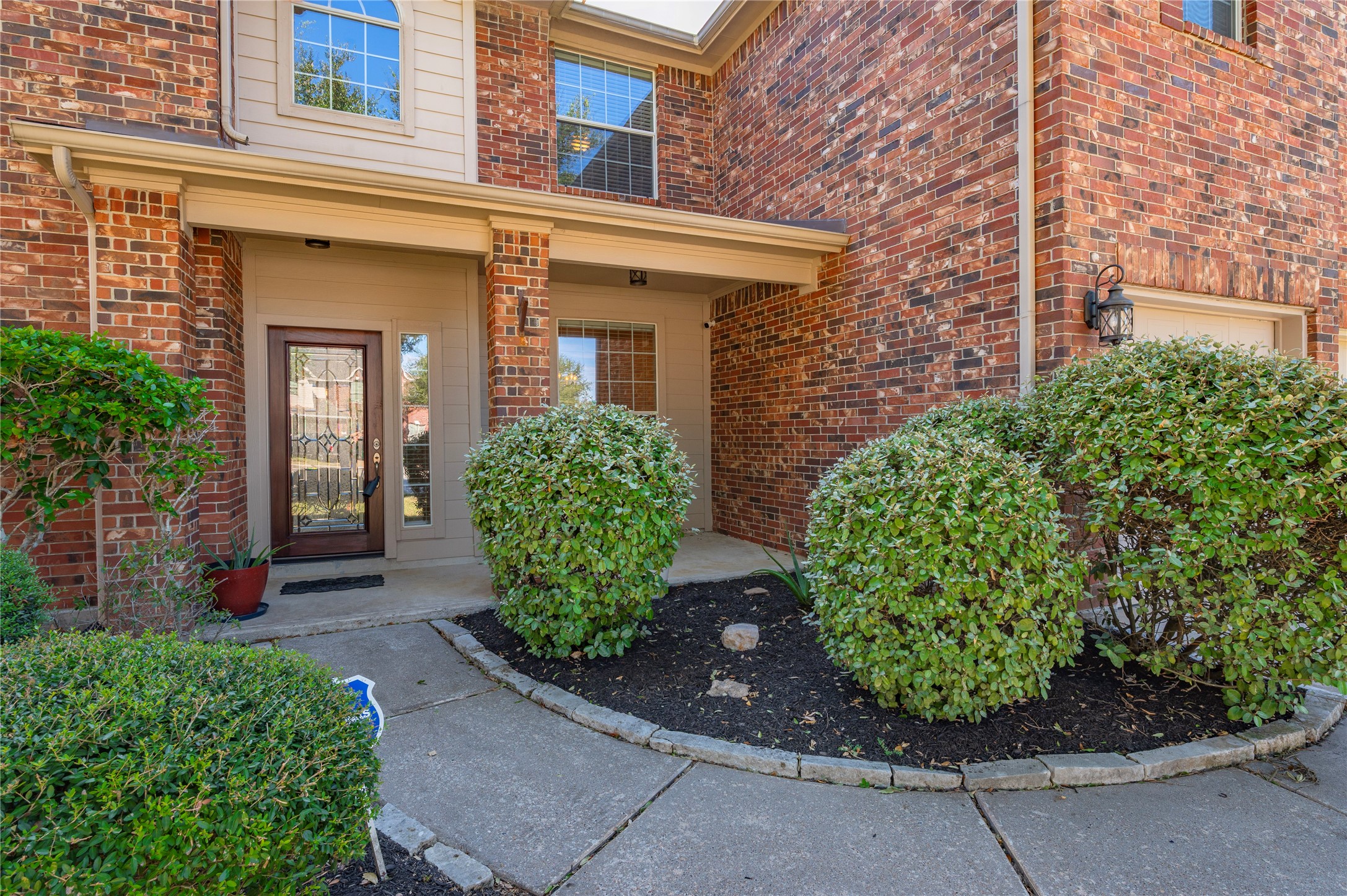 Well-kept landscaping beds line the walkway, adding color and curb appeal right up to the front porch. Well-kept landscaping beds line the walkway, adding color and curb appeal right up to the front porch.