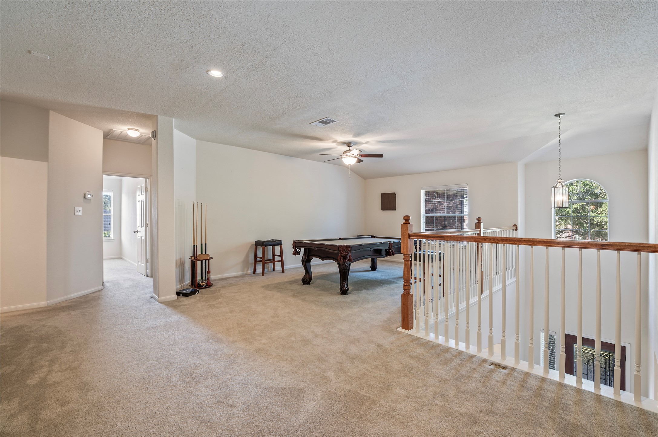 The second-floor landing opens to a huge game room, a great extra living space.