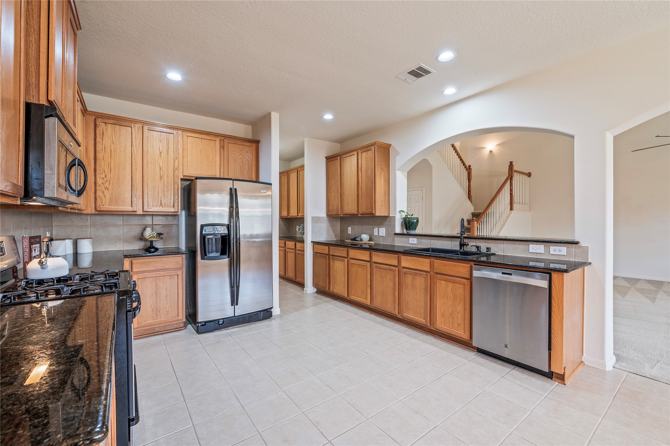 Plenty of counter and storage space in this kitchen, with stainless steel appliances, a gas range and built-in microwave.