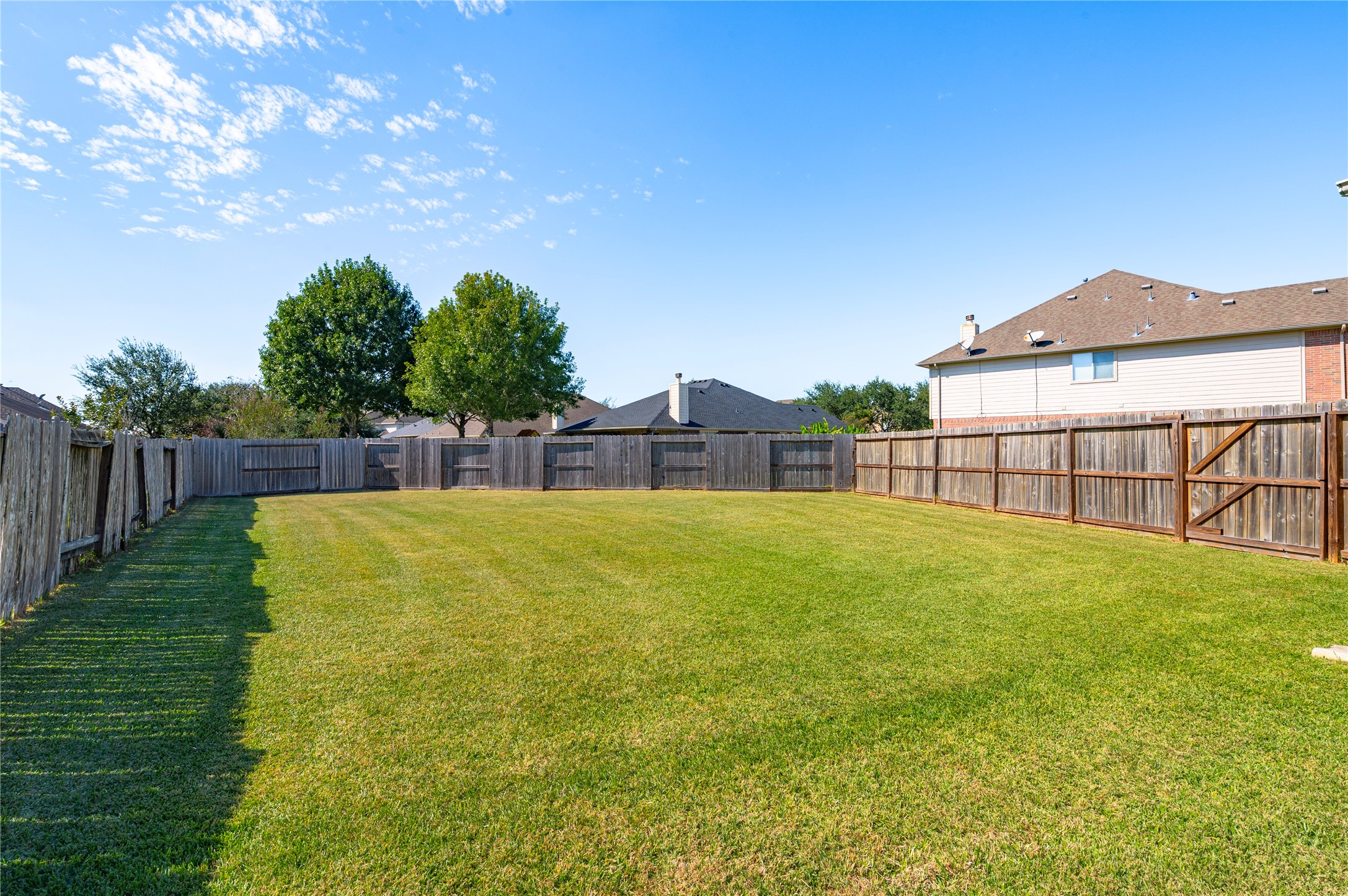 A huge backyard with privacy fencing on all sides, plenty of room for play, pets, gardening or a future pool.