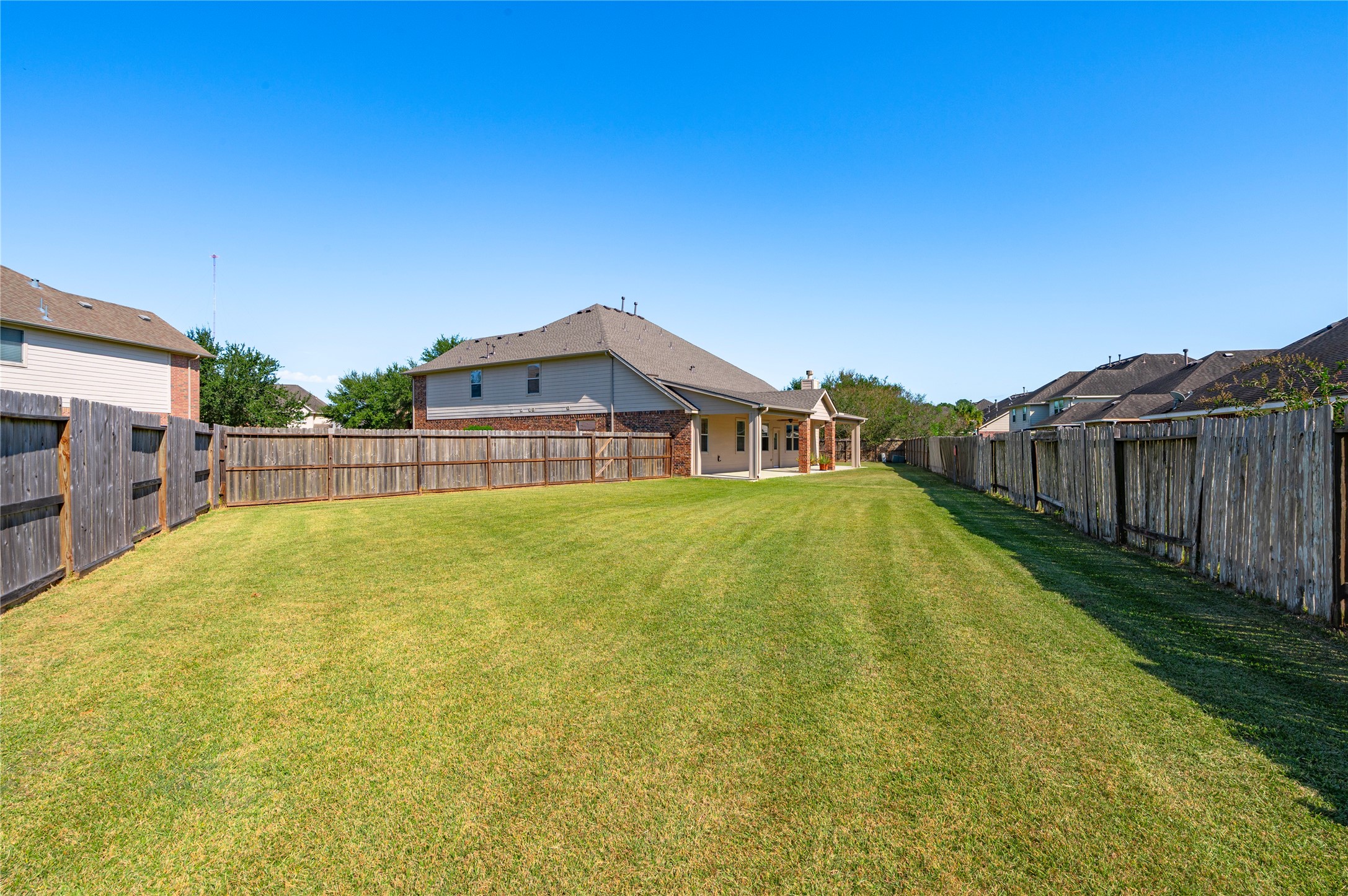 The expansive backyard offers wide open green space to enjoy.