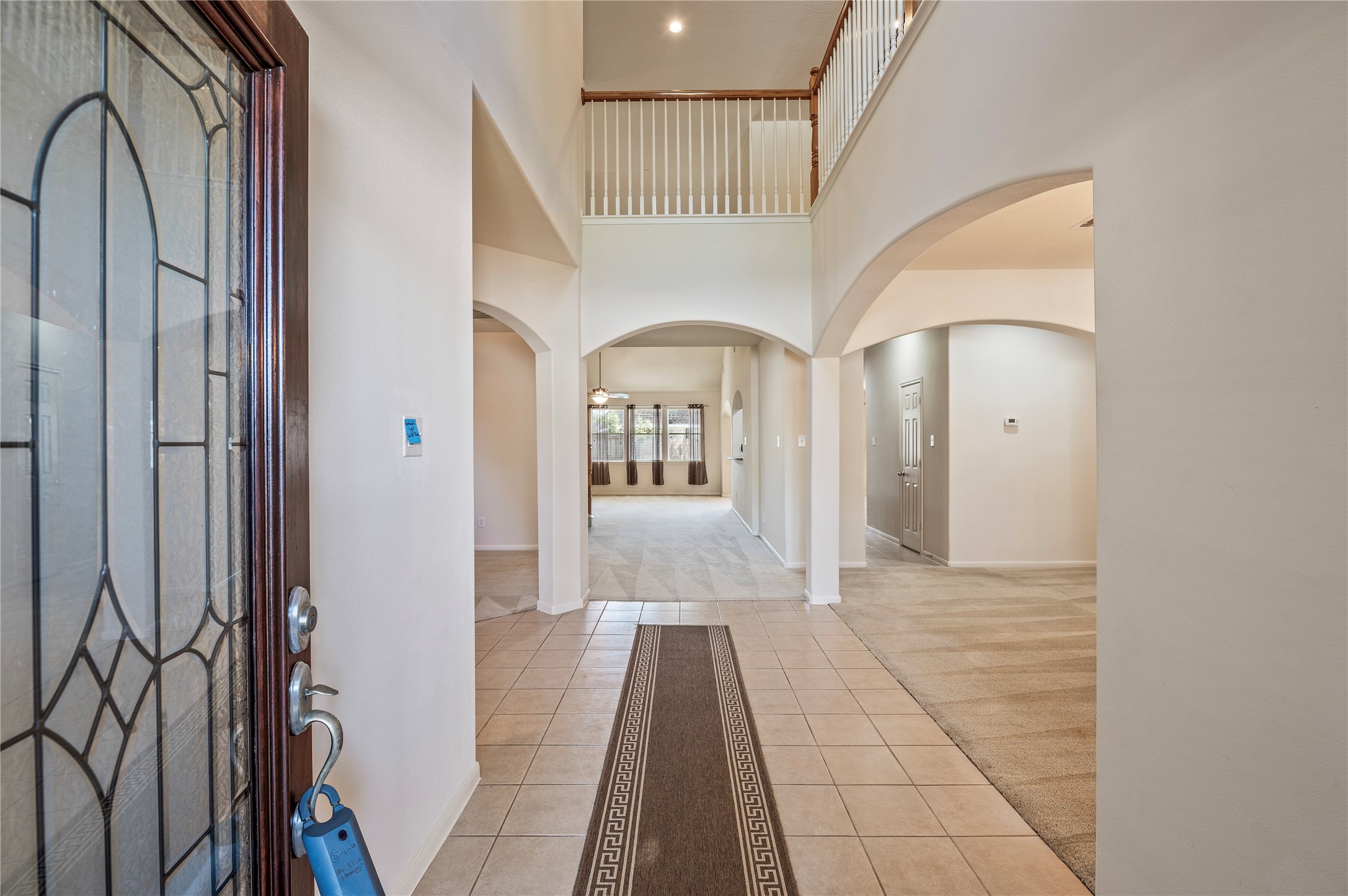 Step inside to a dramatic two-story entry with soaring 19-ft ceilings and durable tile flooring. Step inside to a dramatic two-story entry with soaring 19-ft ceilings and durable tile flooring.