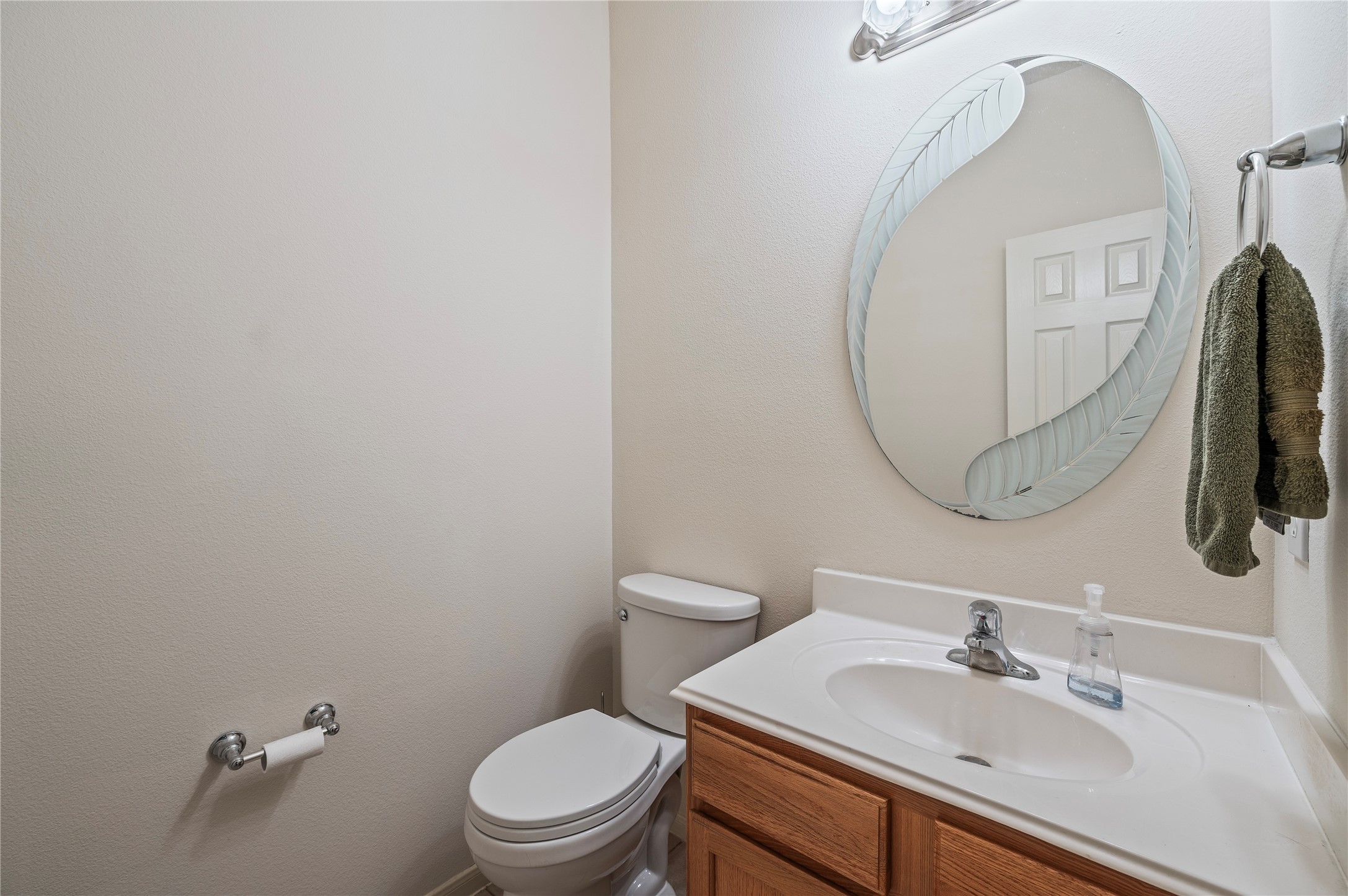 A convenient first-floor half bath for guests, with vanity and tile flooring.