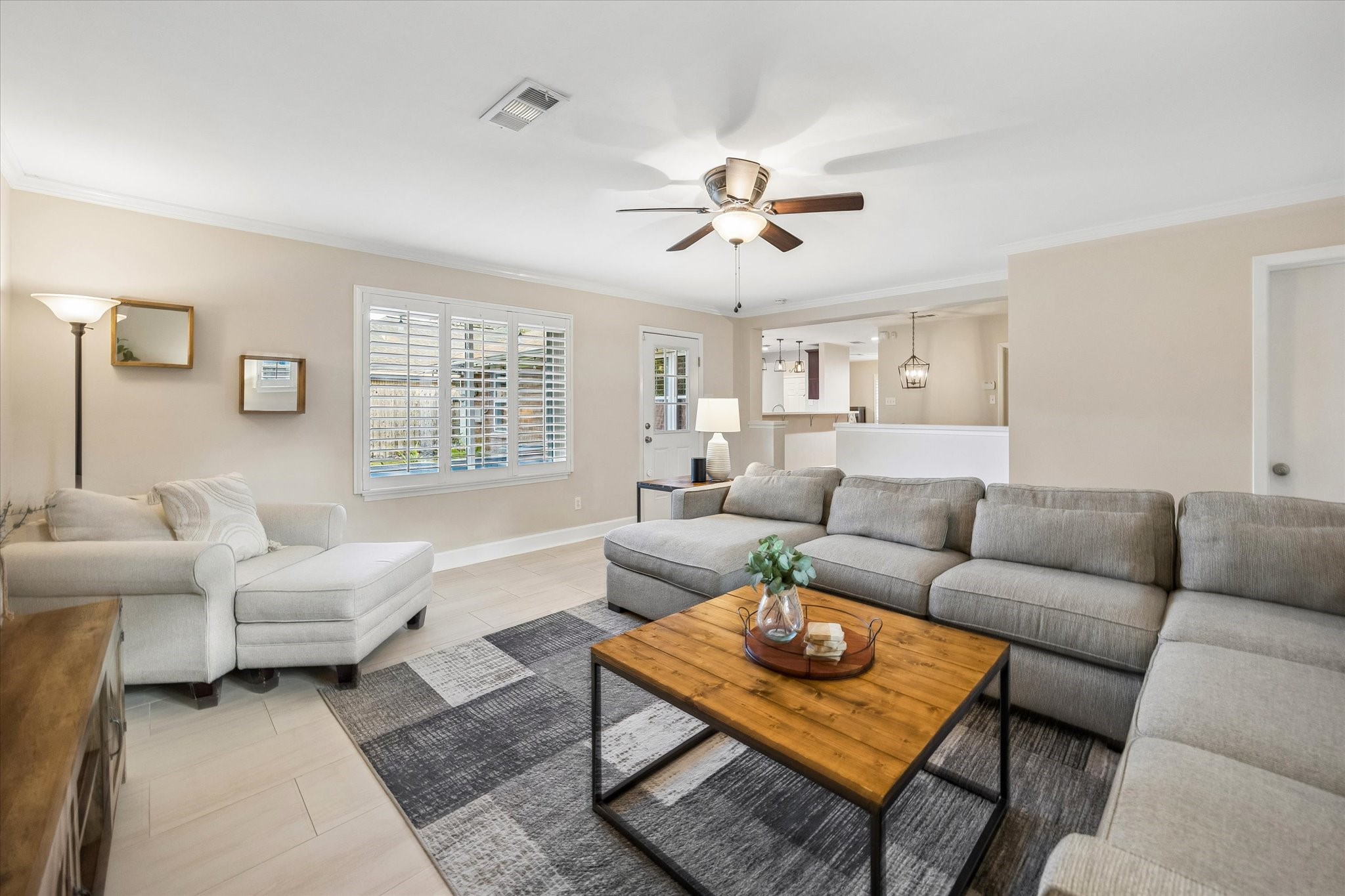 Sightlines from the living room extend through the breakfast area toward the kitchen. Broad openings and a generous living footprint make this connected layout a highlight for both everyday routines and larger gatherings.