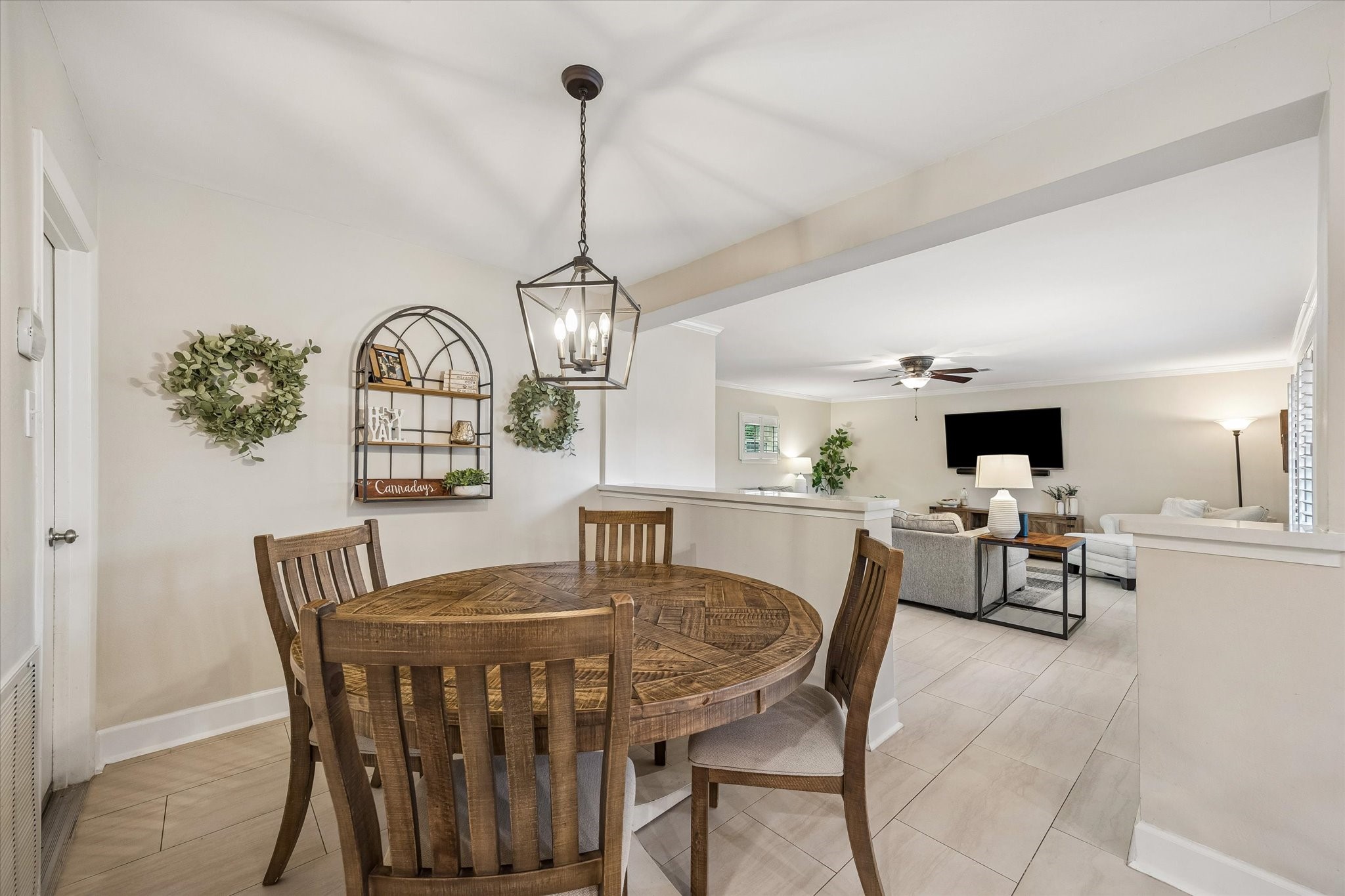 Breakfast area connects the kitchen with the spacious living room, creating a natural gathering point for everyday meals. Wide openings keep movement and conversation flowing between these frequently used spaces.