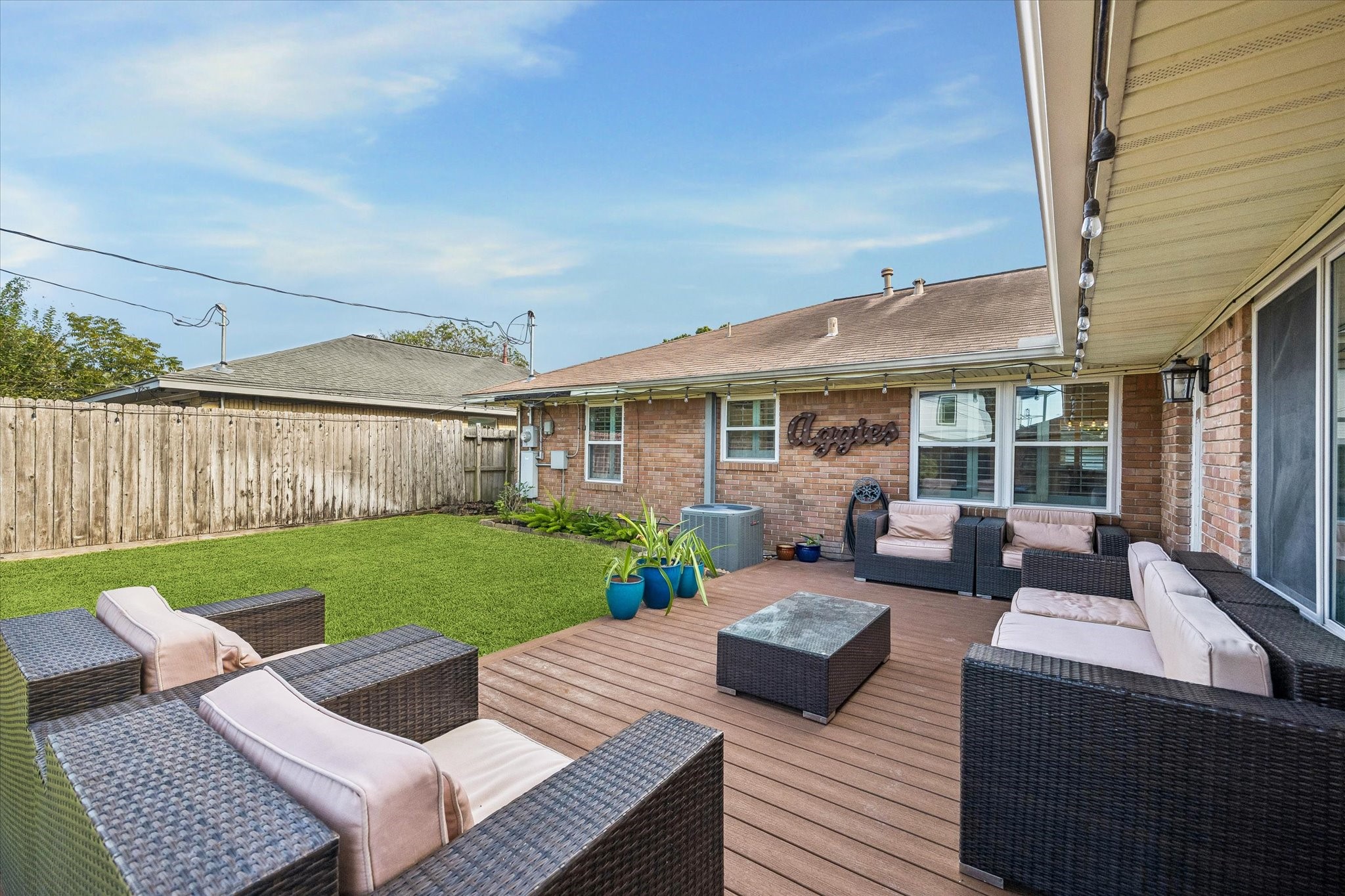 Views from the deck take in the lawn and the backyard's distinctive layout. Space for outdoor dining and relaxing connects directly with the yard, making the deck a useful extension of the home's main living areas.