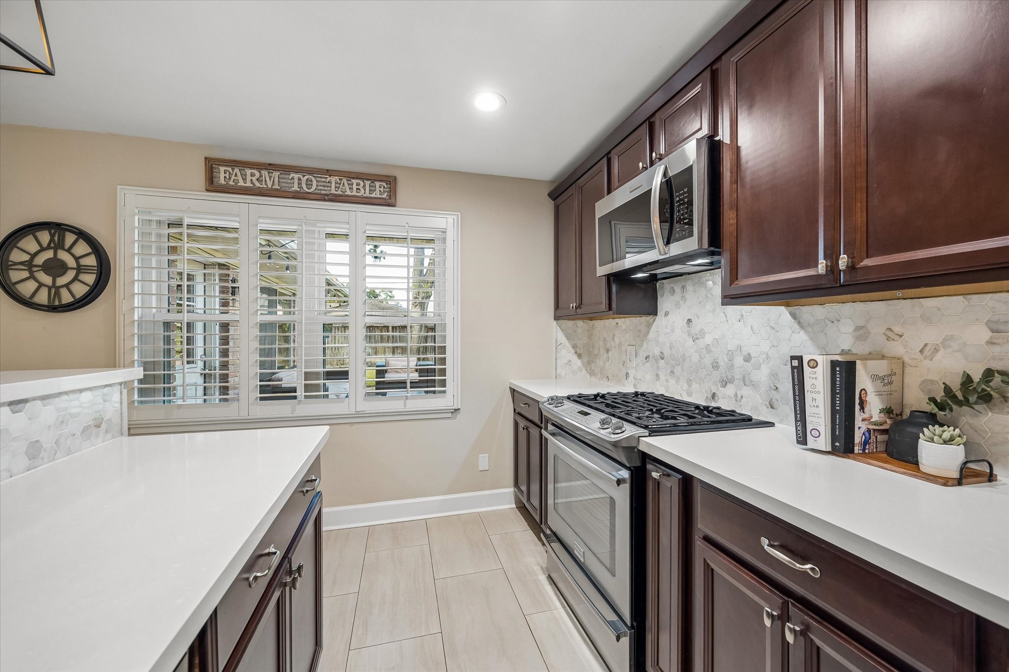 Ample cabinetry and counters provide room for meal preparation and kitchen storage. Stainless steel appliances, a window above the work area and an efficient arrangement keep daily cooking convenient.