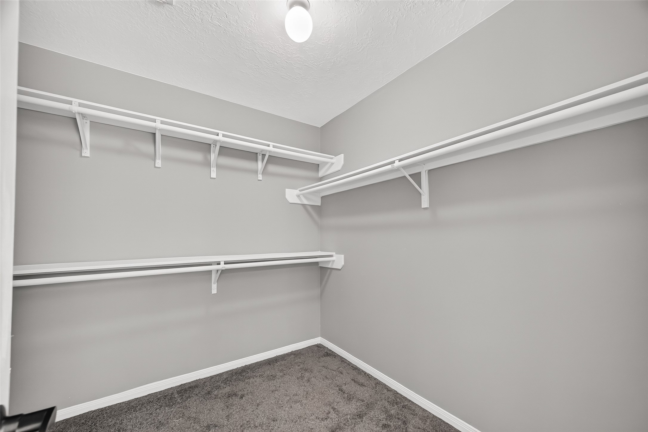 Spacious walk-in closet with ample shelving and hanging space, perfect for organizing your wardrobe.