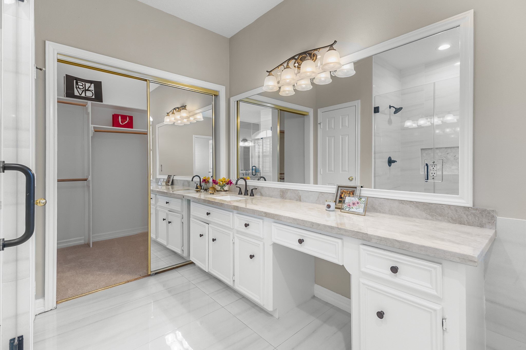 An extended vanity with ample counter space and storage brings everyday convenience to the primary bath.