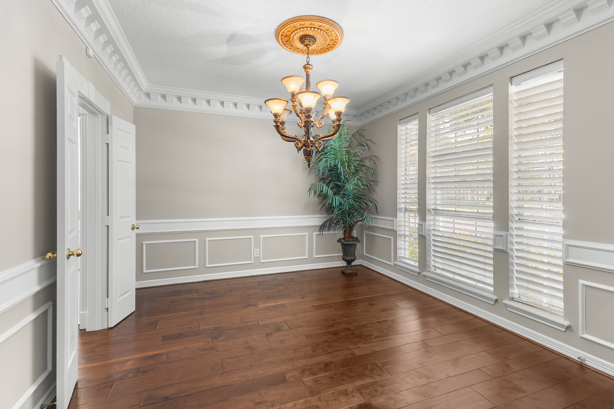 Classic wainscoting, crown molding and a statement chandelier frame a gracious setting for intimate dinners and celebratory gatherings.