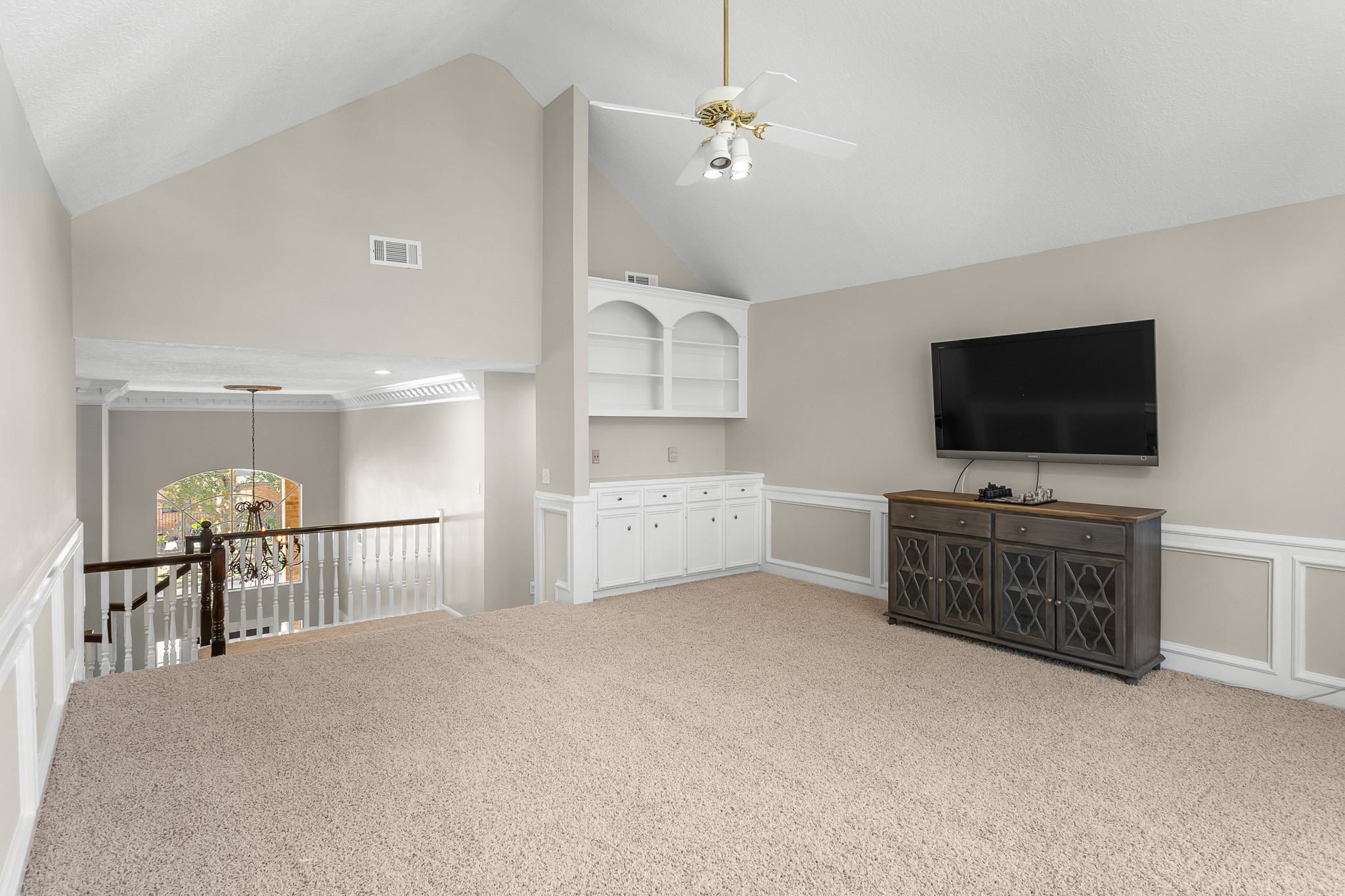 Built-in cabinetry and generous floor space make this upstairs retreat ideal for media, games or a flexible gathering area.