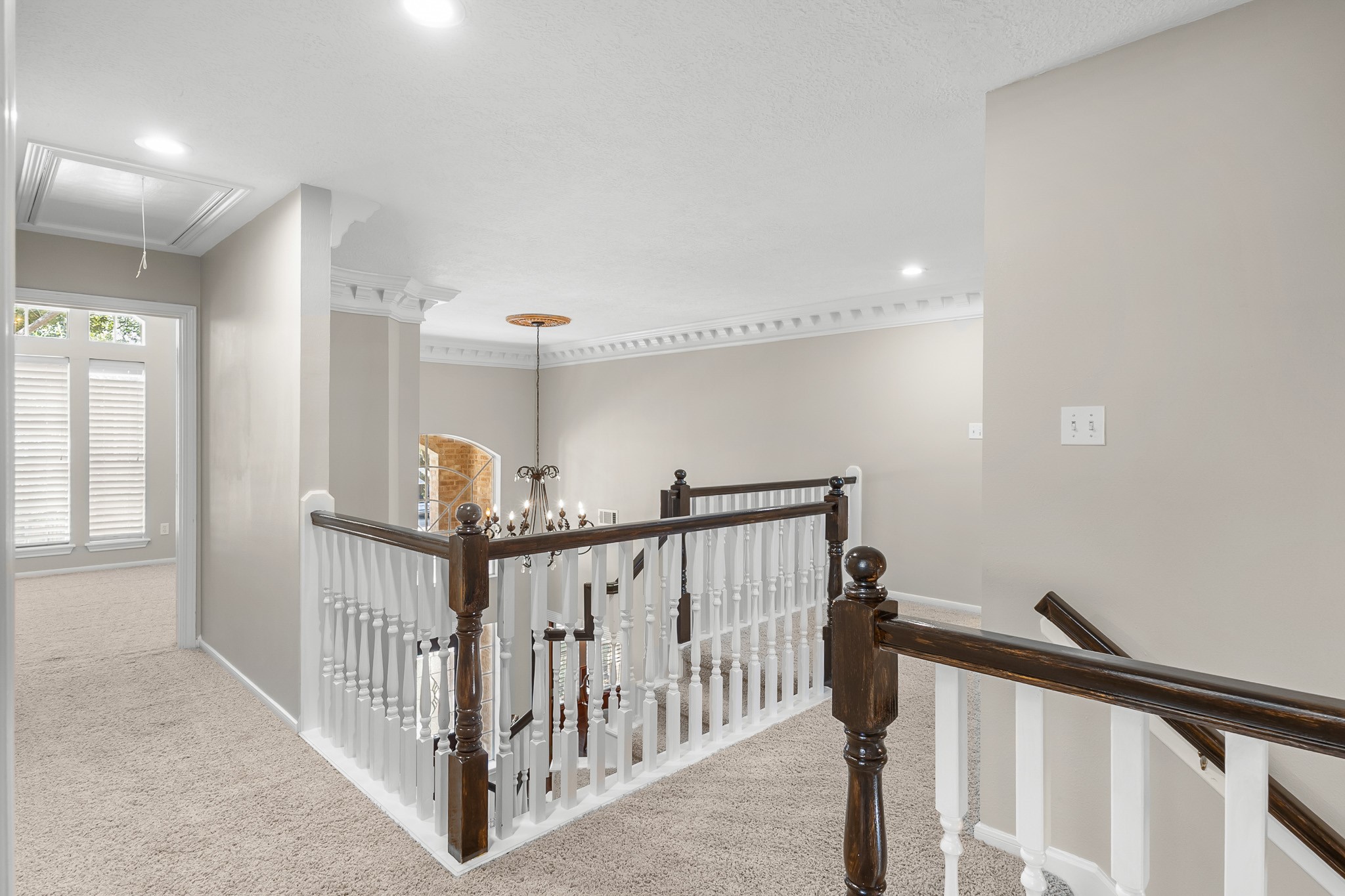 An elevated perspective showcases the open foyer below and the architectural volume connecting the homes two levels.