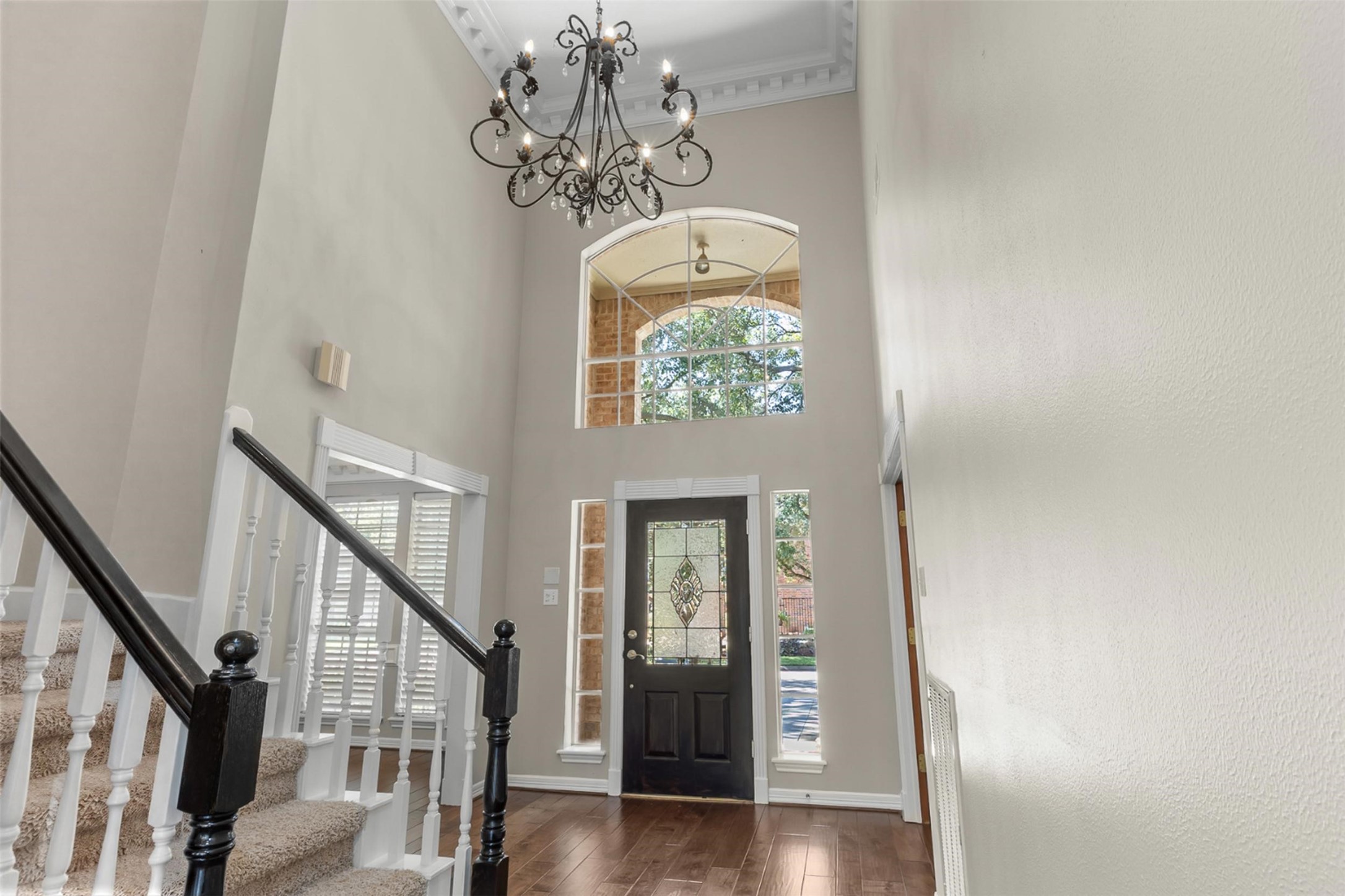 Beautiful chandelier graces the entry. This elegant fixture serves as a stunning focal point, casting a warm and inviting glow