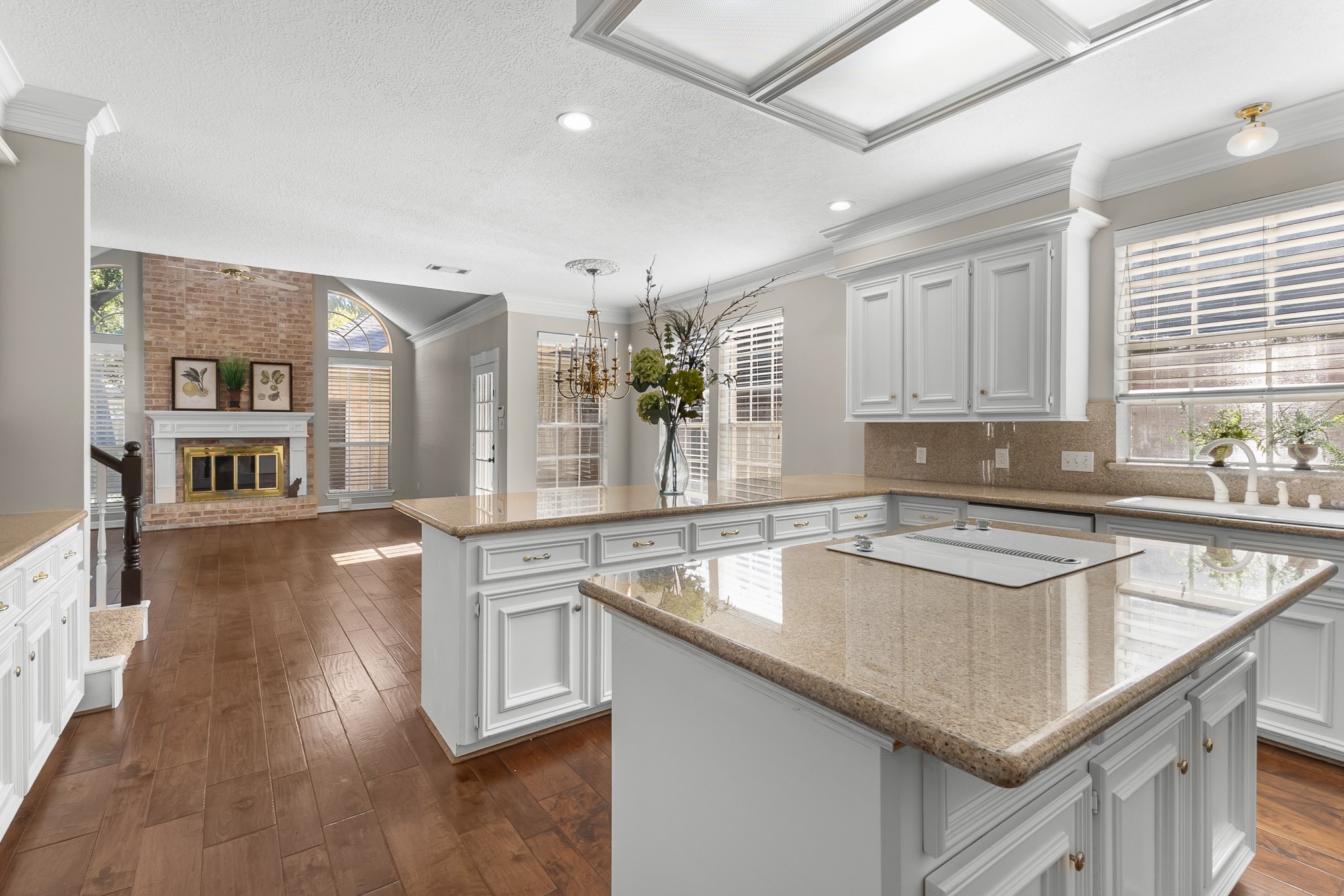 The expansive kitchen opens toward the family room, creating an inviting flow between meal preparation and everyday gathering spaces.