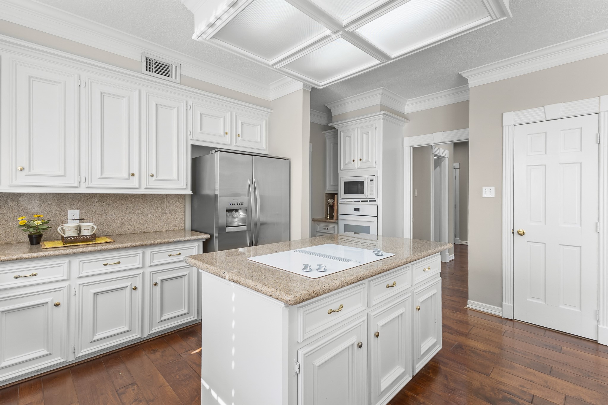 Detailed cabinetry, stainless-steel appliances and a generous central island bring together classic styling and everyday functionality. [Refrigerator is included]