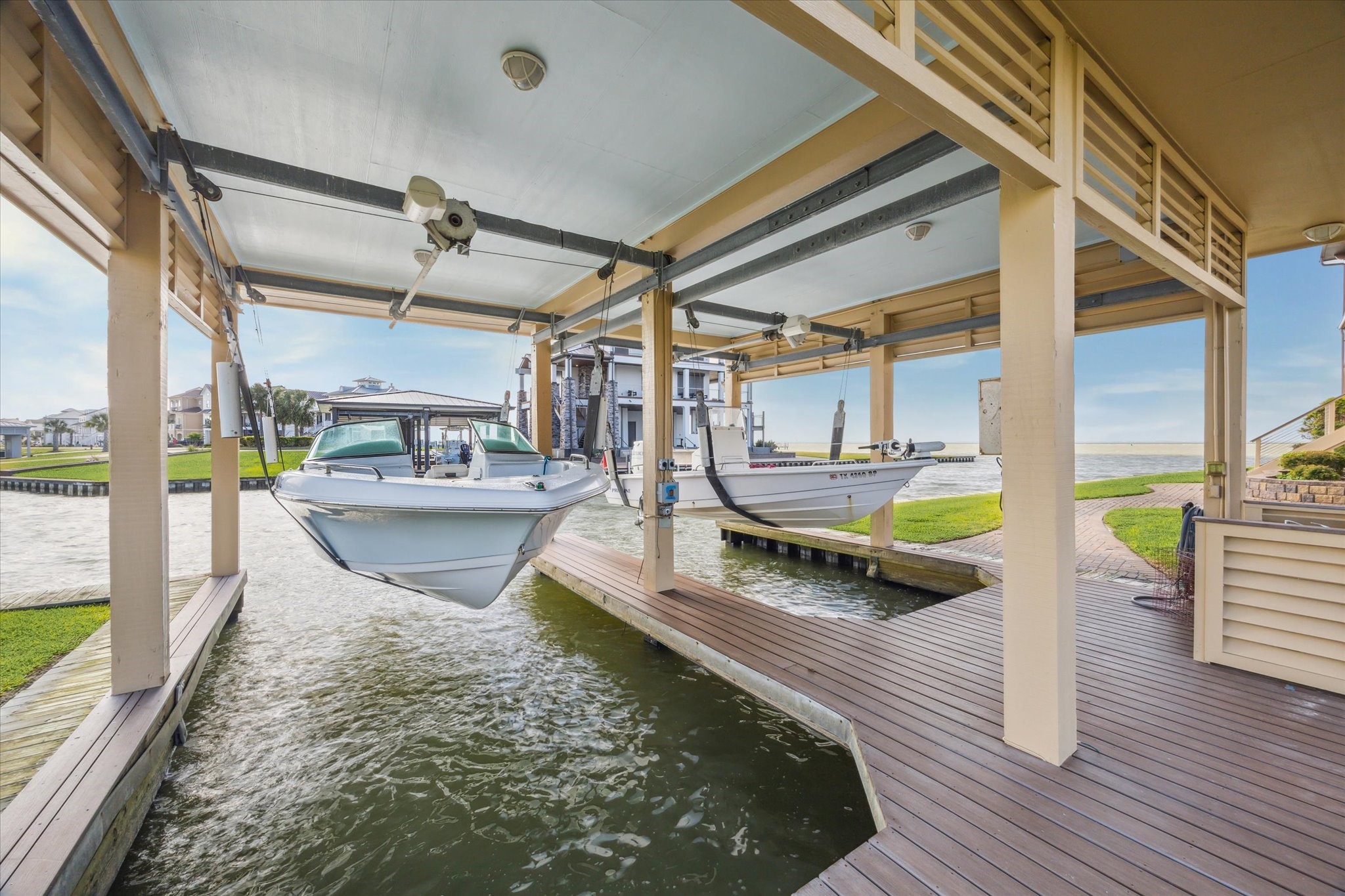 The boat house is built over a double slip and features separate steel-mounted lifts with capacities of 7,500 lbs. and 6,000 lbs. Designed for secure and convenient boat storage. A fish cleaning station is also included