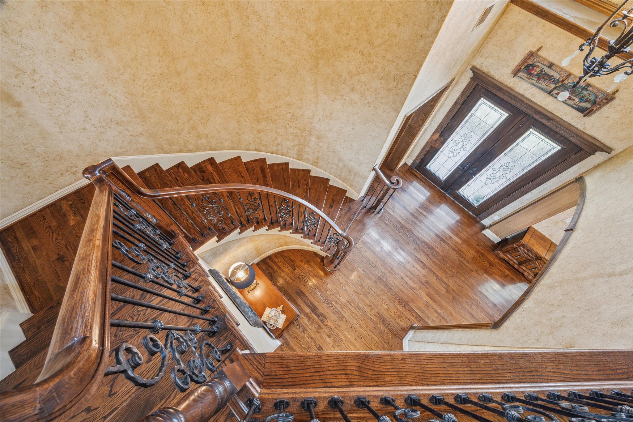 A view from the stairway overlooking the leaded glass double entry doors. Spray in foam insulation in all exterior walls and under subfloor of main living area
