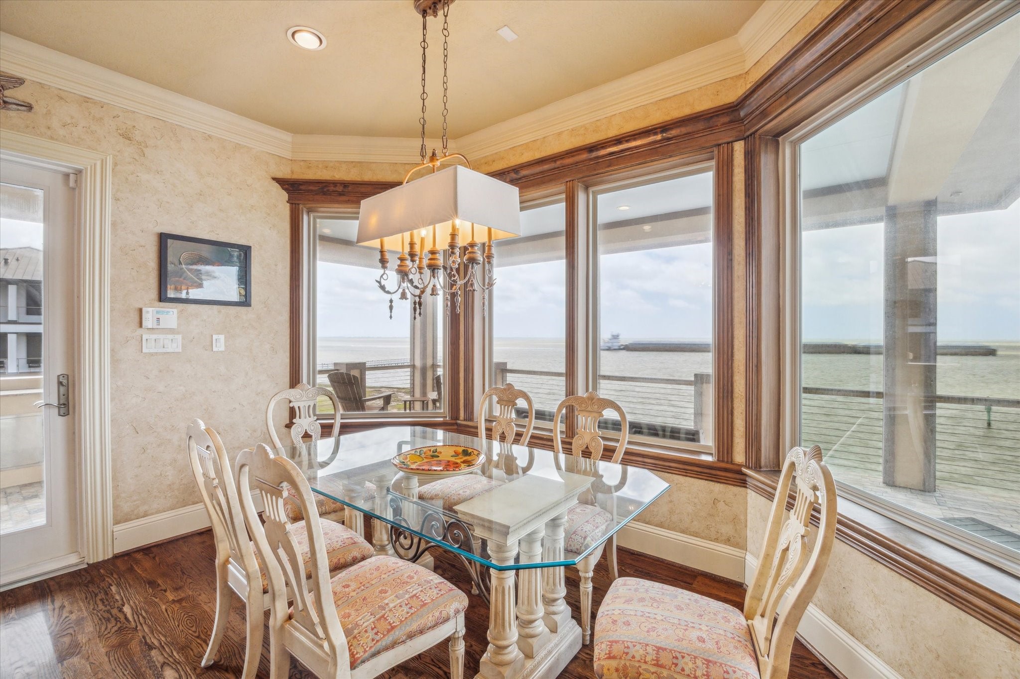 The breakfast room, located just off the kitchen, offers easy access to the back terrace and stunning bay viewsperfect for casual meals and indoor-outdoor living