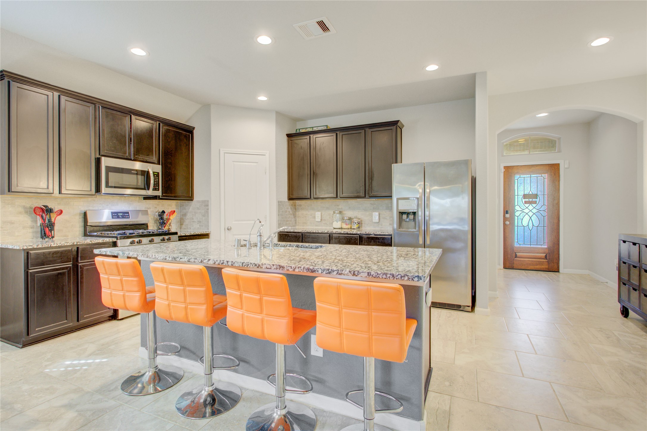 Designed for entertaining! Enjoy granite countertops, rich cabinetry, stainless steel appliances, and a breakfast bar with seating for four. Fridge is included!