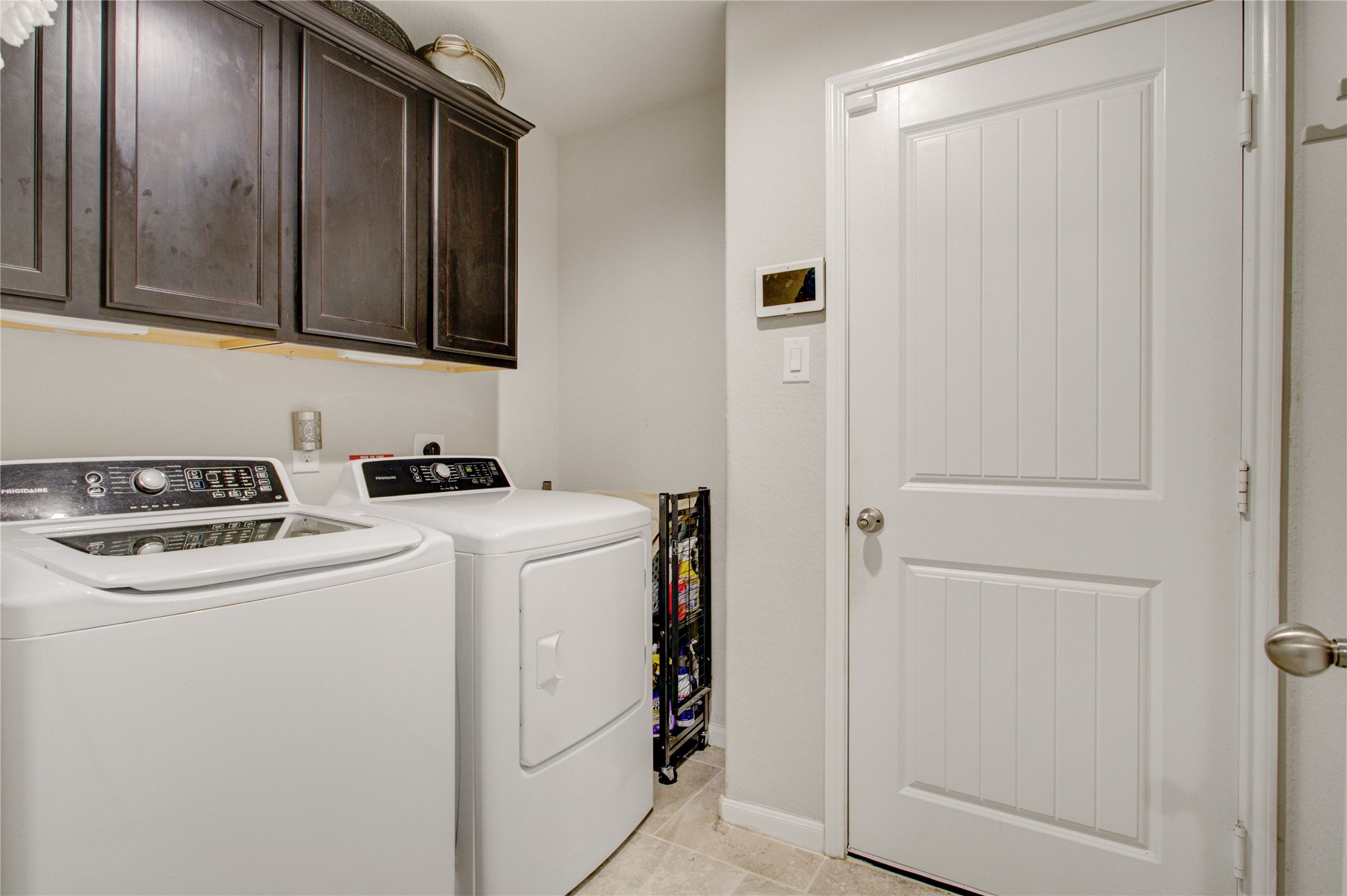 Enjoy a dedicated laundry room with overhead cabinetry for added storage. Washer and dryer are included with the home!