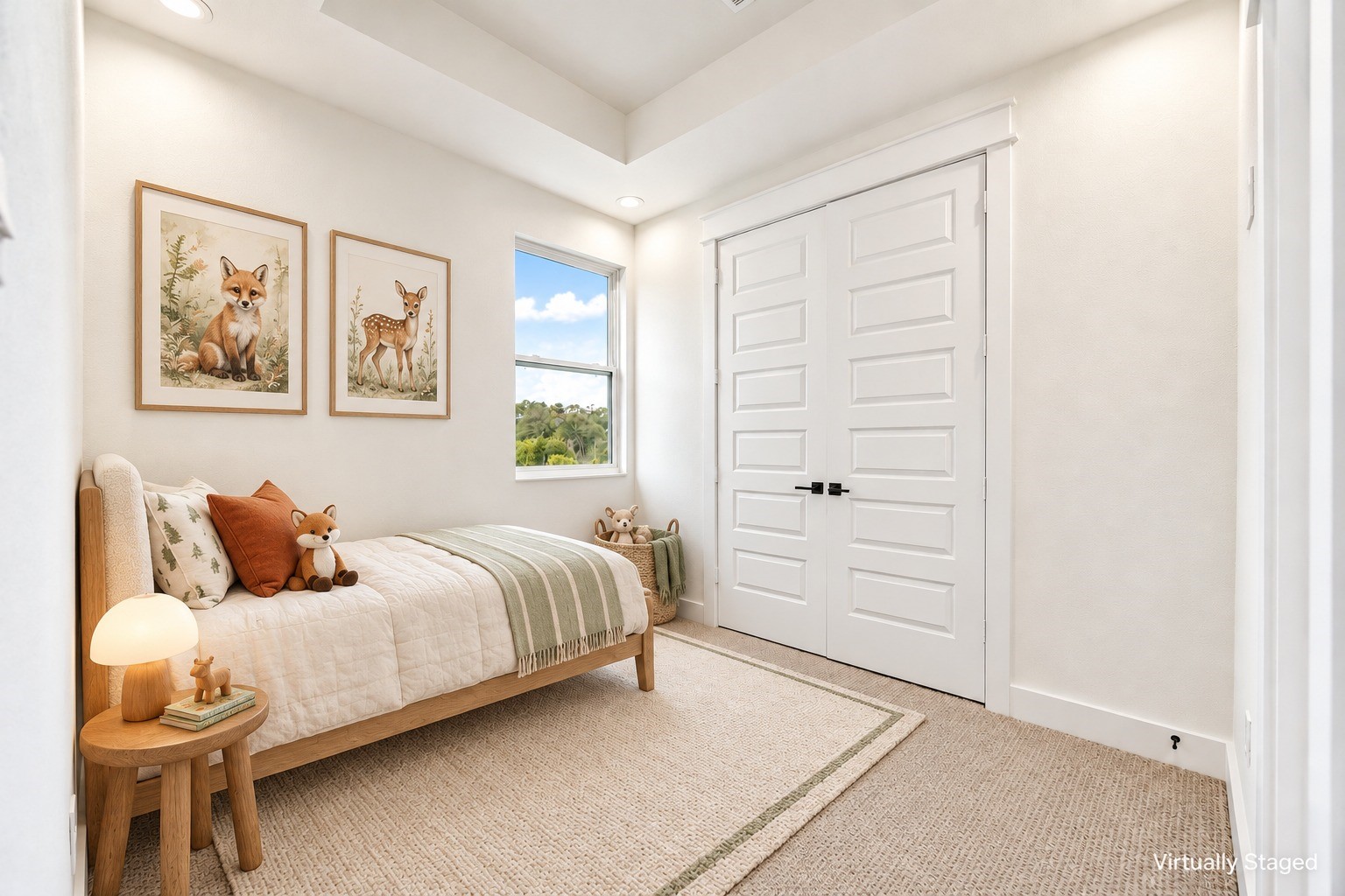 Charming third floor secondary bedroom styled as a nursery, highlighting a deep tray ceiling detail, large closet doors, neutral carpeting, and a window showing clear sky views. Complete with ensuite full bath. *Virtually staged