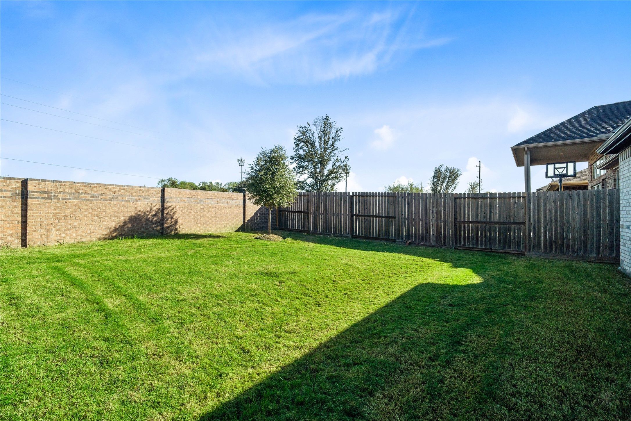 The expansive backyard offers a wonderful blank canvas, providing a completely flat, sprawling green lawn with privacy fencing and no immediate rear neighborsoffering endless possibilities to build a custom luxury pool, playscape, or garden oasis.