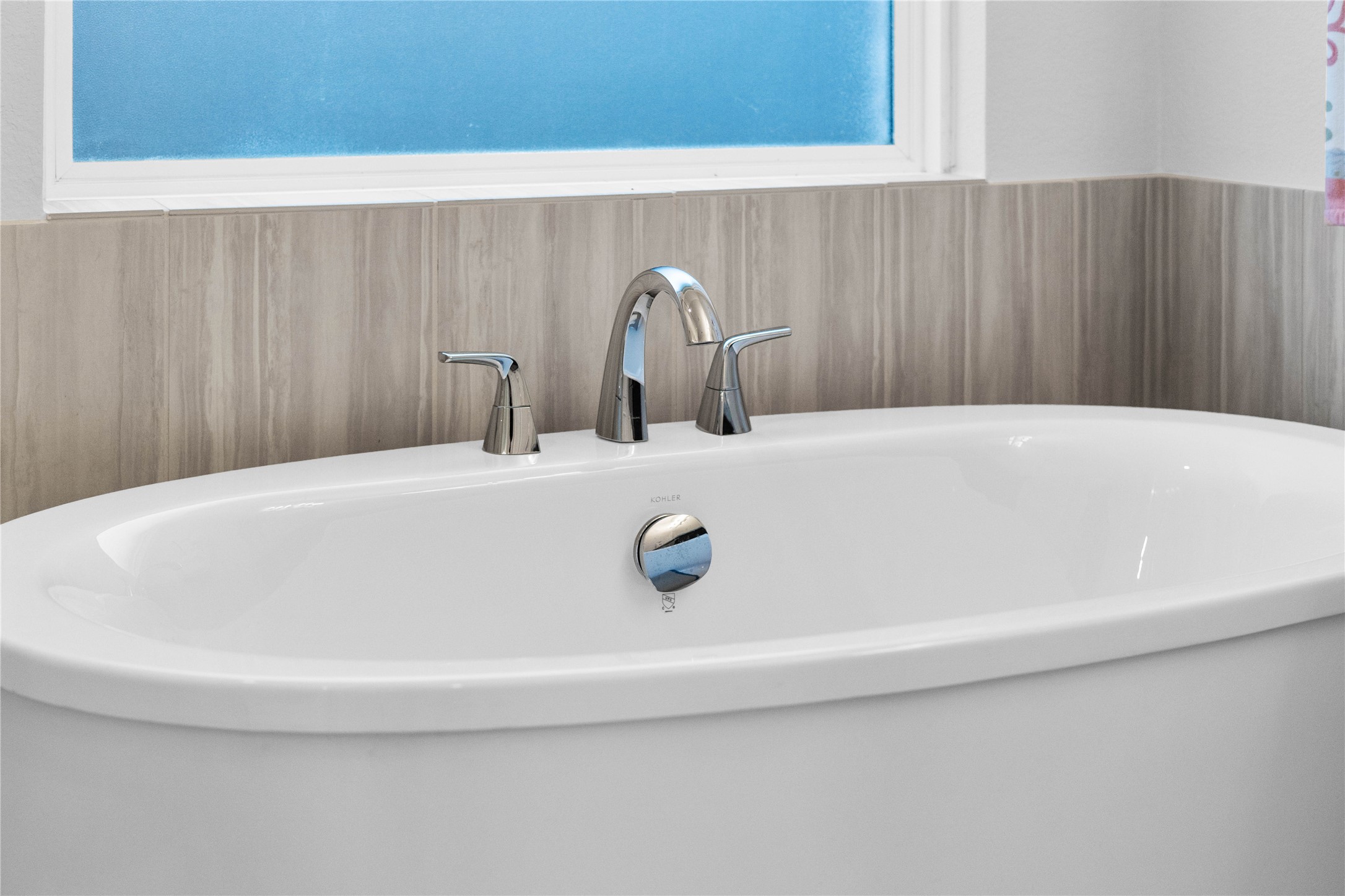A close-up view highlighting the sleek chrome plumbing fixtures on the deep freestanding tubthe perfect spot for soaking after a long day and enjoying the pure relaxation it provides.