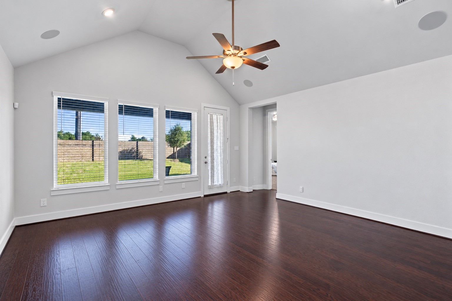 The light-filled family room transitions effortlessly to outdoor entertaining via a rear glass door that leads directly out to the covered patio and spacious backyard.