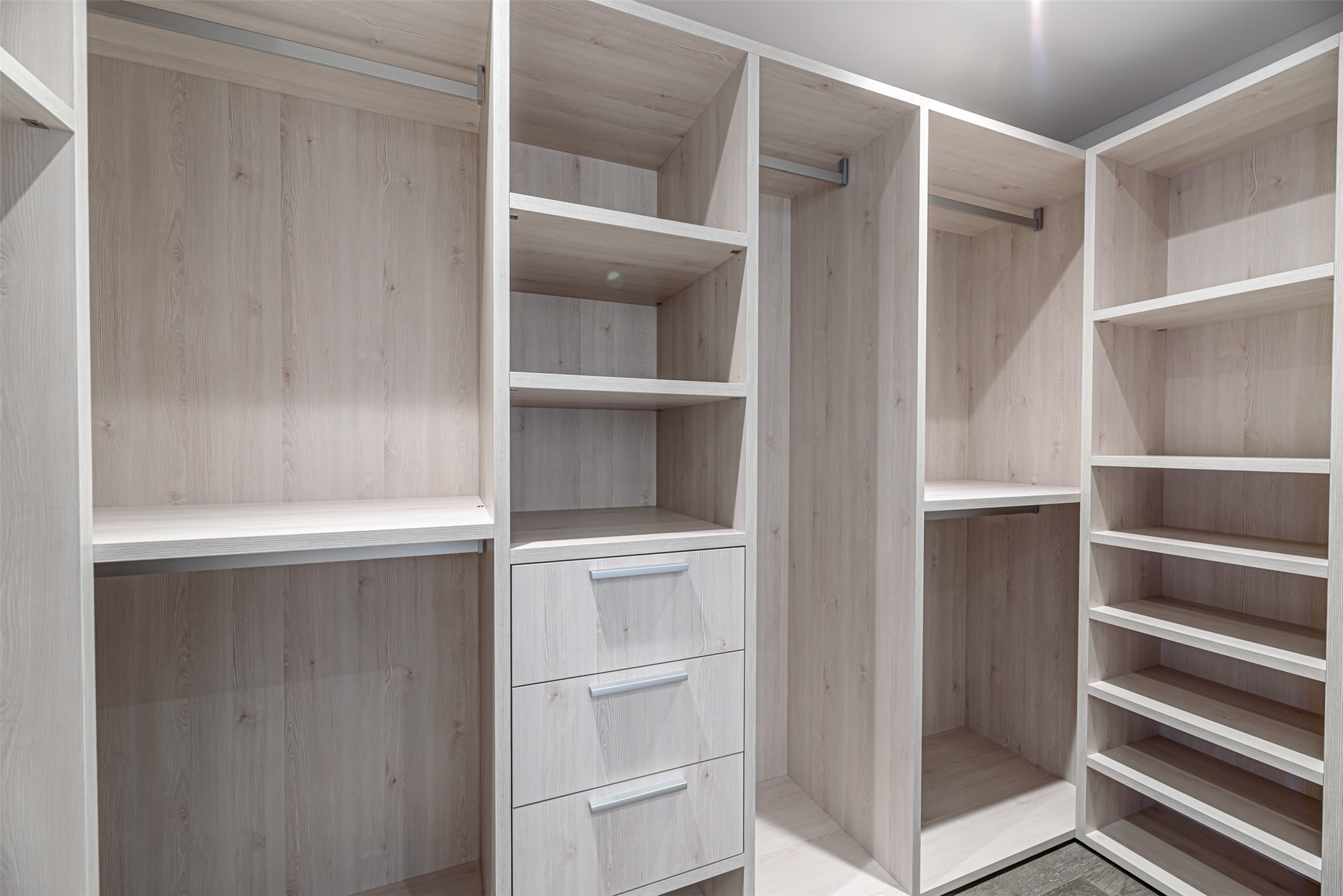 Bonus walk-in closet outfitted in designer closet system custom built by Eggersmann.