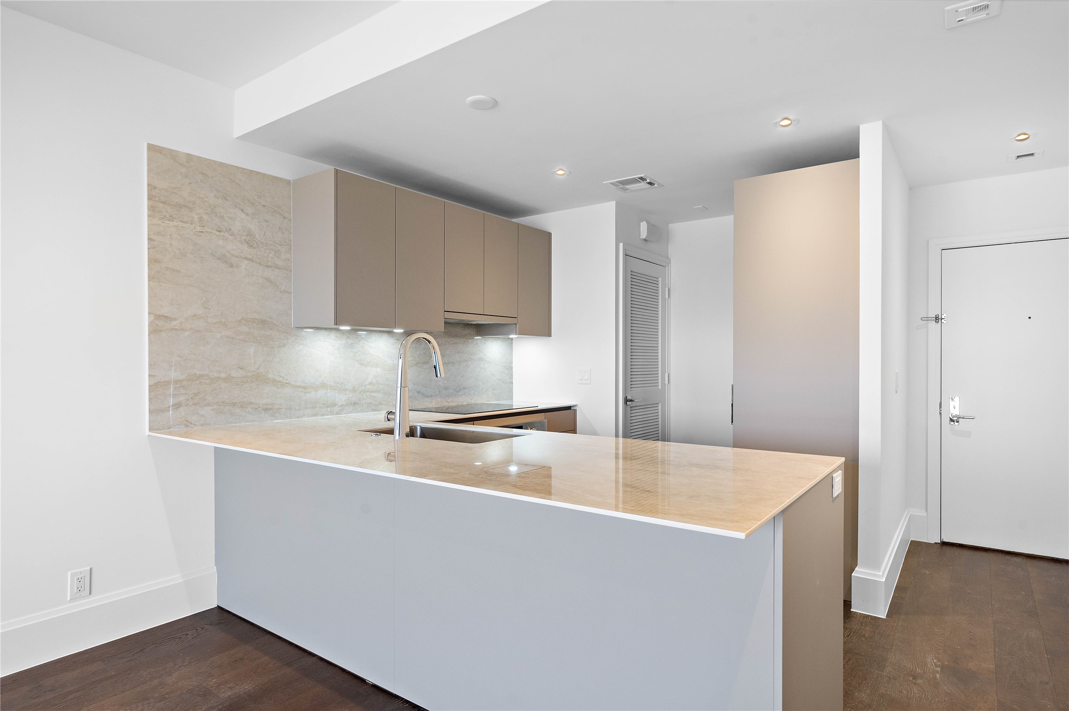 Residence is entirely hardscape, including wide plank engineered hardwood and large format tile floors.