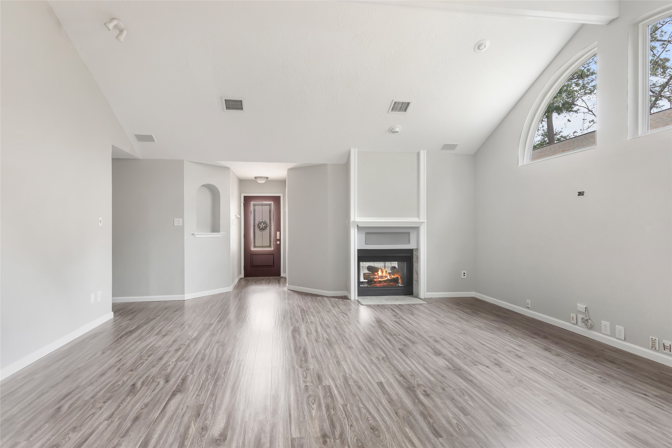 Family room looking towards front door with shared fireplace
